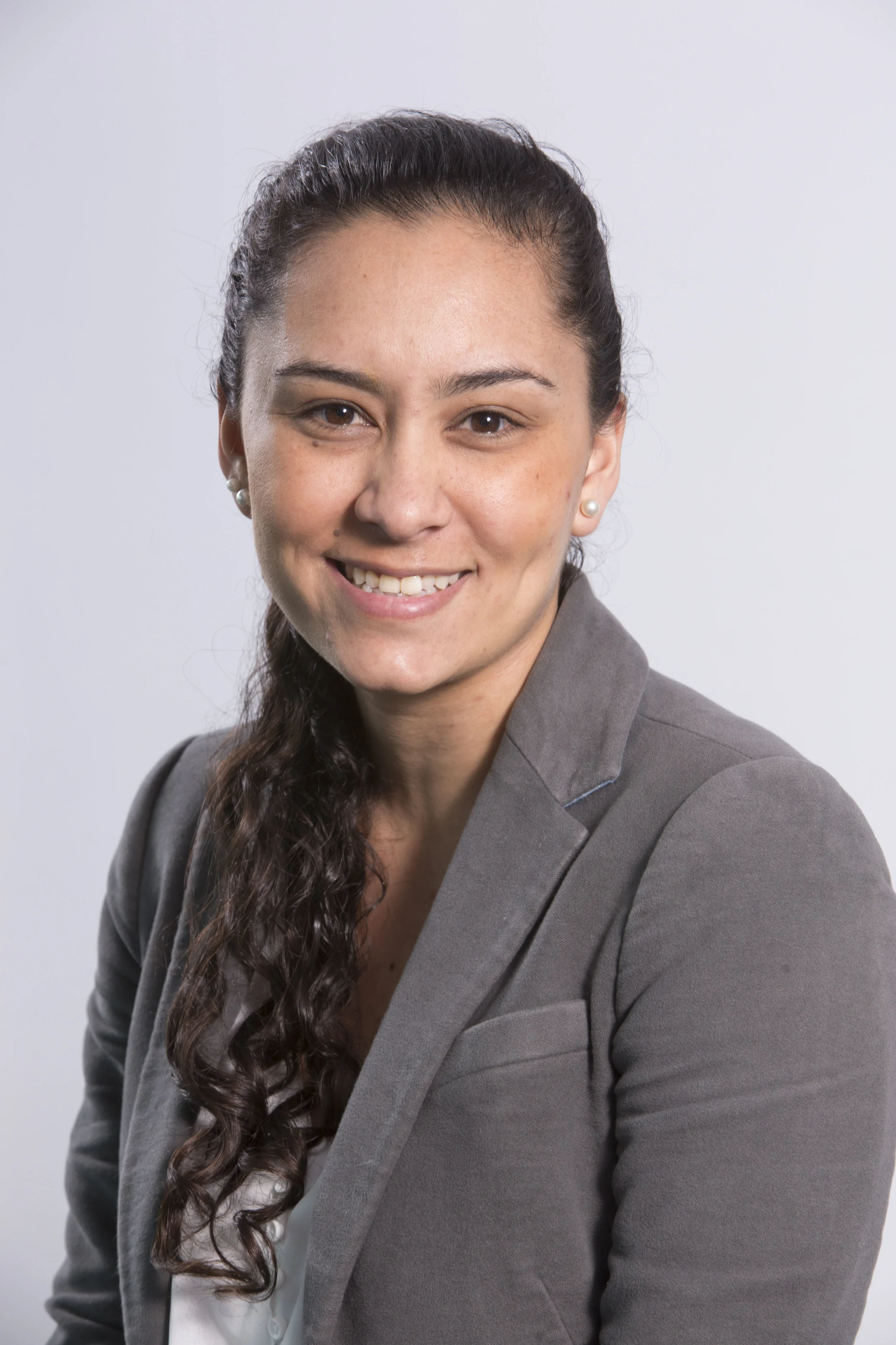 Image description: professional photo of Thalia dressed in professional attire.