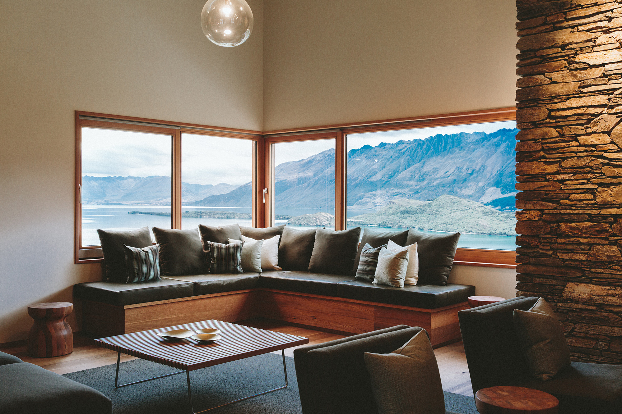  Living room setting with windows looking out at a mountain view  