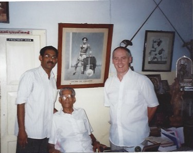 Phillip Zarrilli with Gurukkal Govindankutty Nayar and Sathyan in the office at CVN Kalari, Thiruvananthapuram. The image behind Gurukkal is of his father, CV Narayanan Nayar.