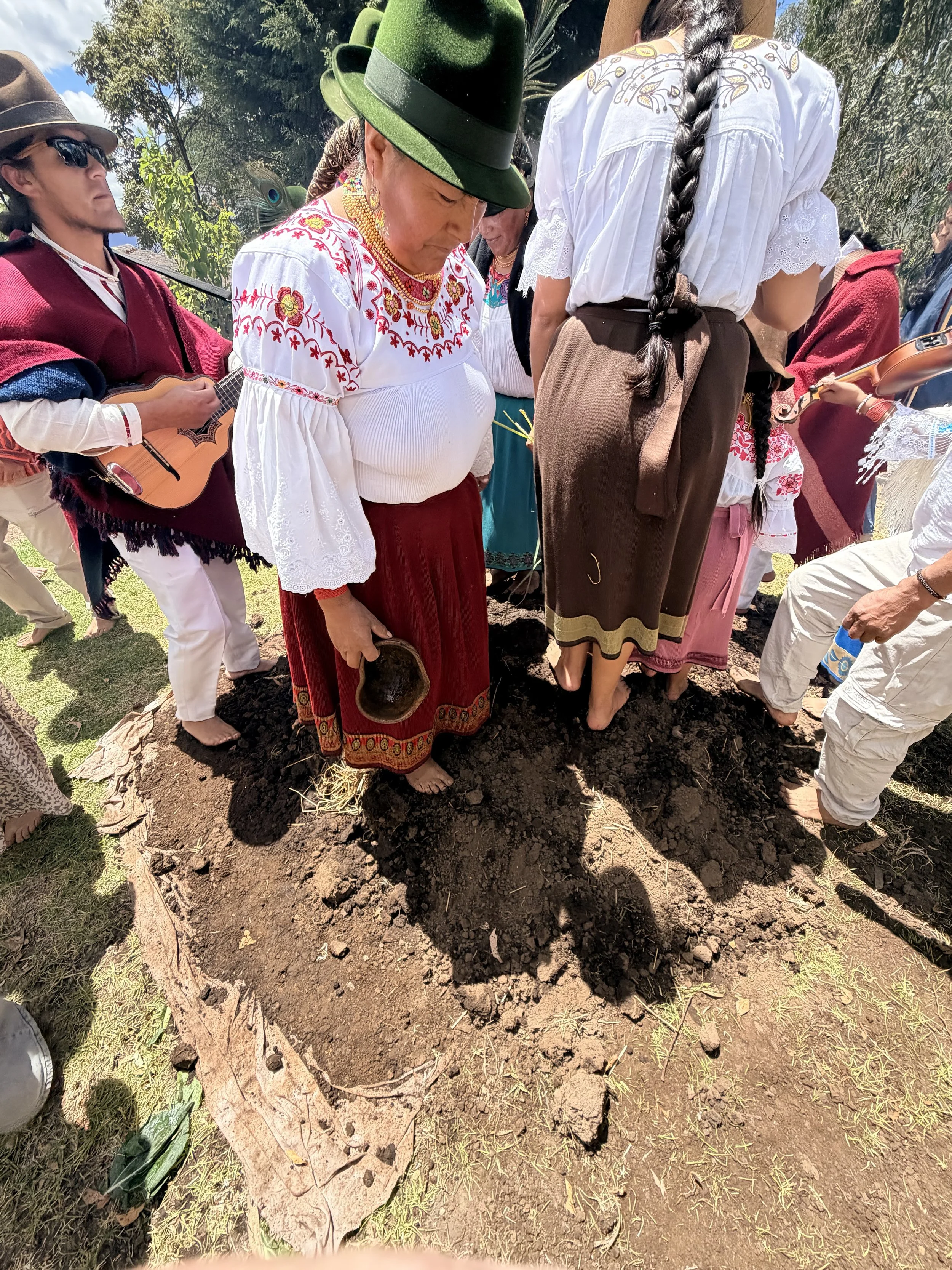  Then came the fun part! Everyone, including the gringos, removed our shoes and danced on the soil to pack it down. It was so fun.  See a video here»  