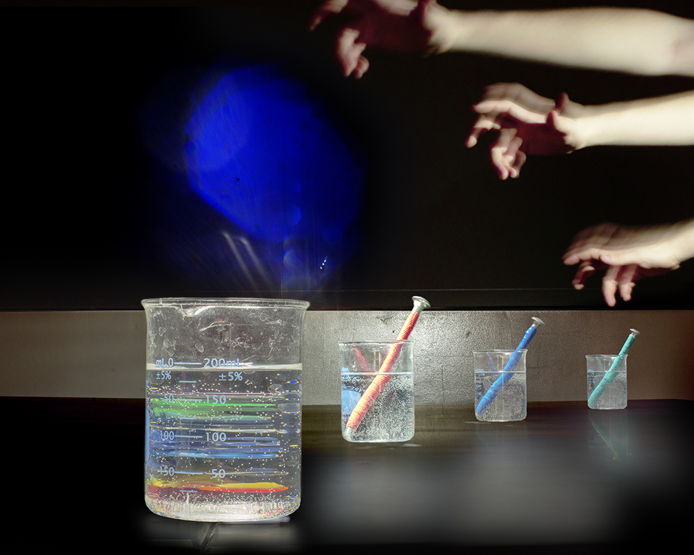 stack of rules behind a beakerbja.jpg