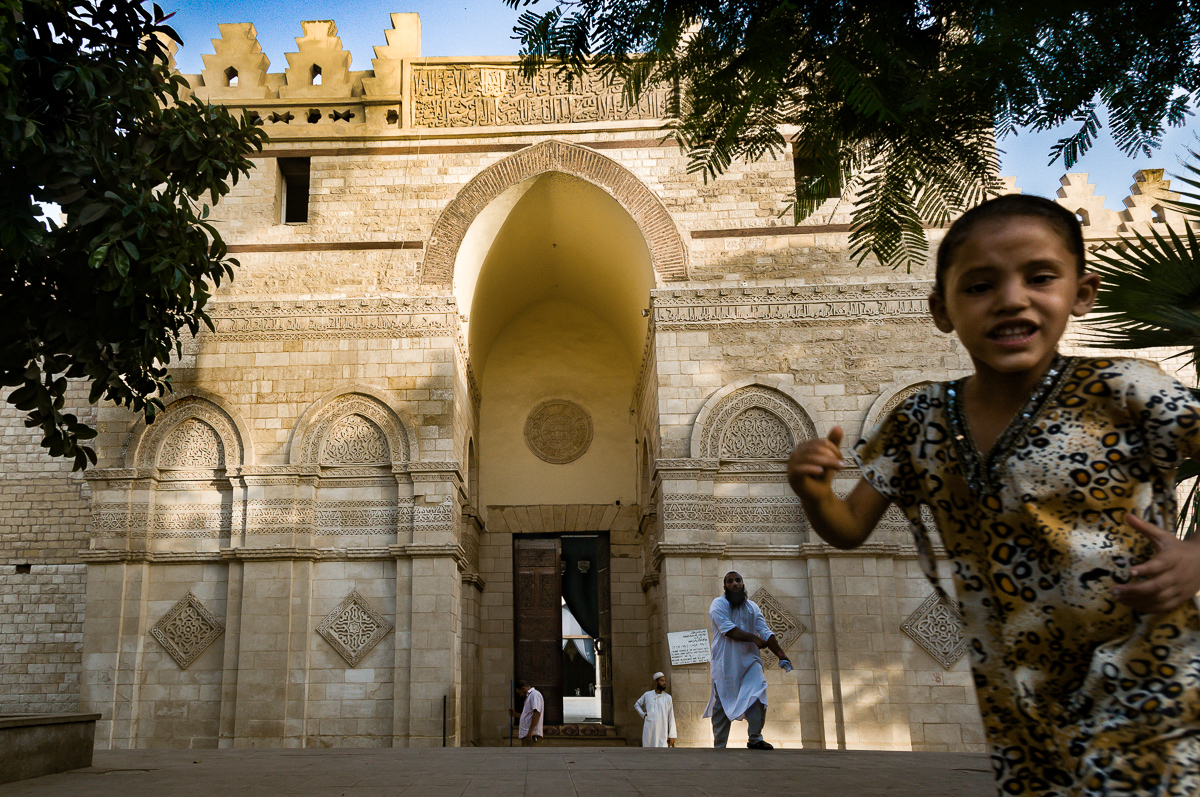 Boy Running in front of Mosque, Cairo, Egypt