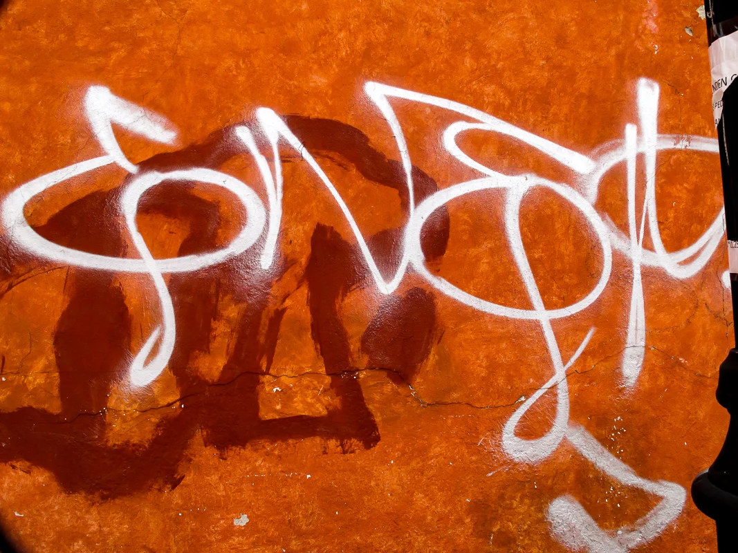 Graffiti on Orange Wall