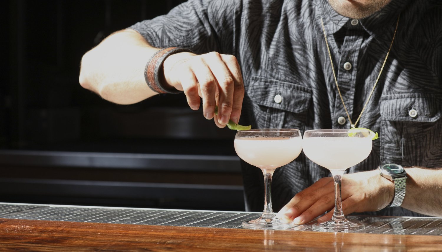 bartender prepares two cocktails