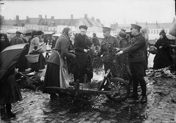 Behind the line in Bailleul, France, soldiers buying mistletoe.