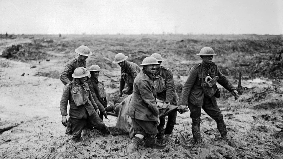 Medics up to their knees in mud.