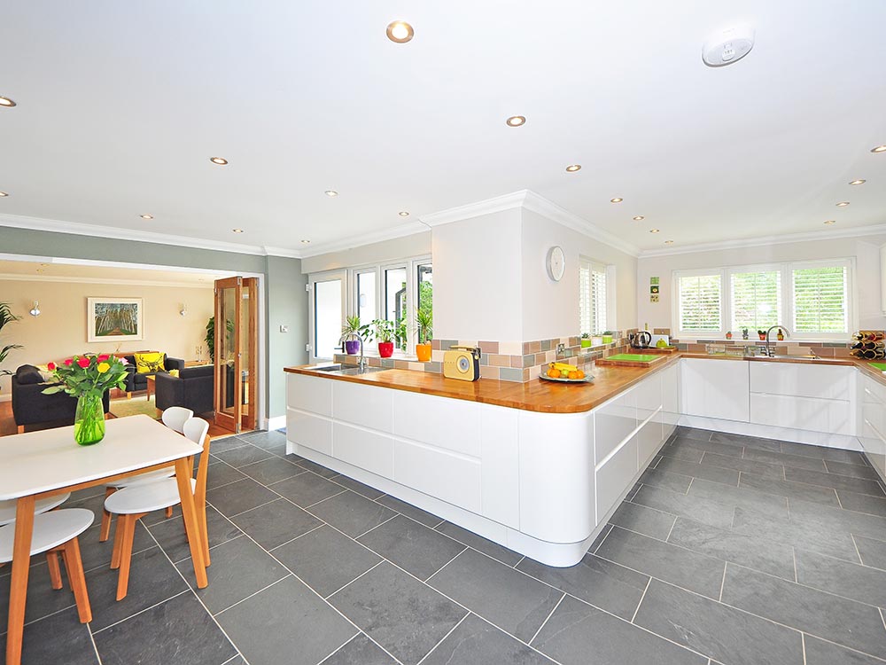 photo-of-kitchen-with-dark-tiles-with-white-grout-and-modern-table-and-chairs-in-an-open-concept-home-1000x750.jpg