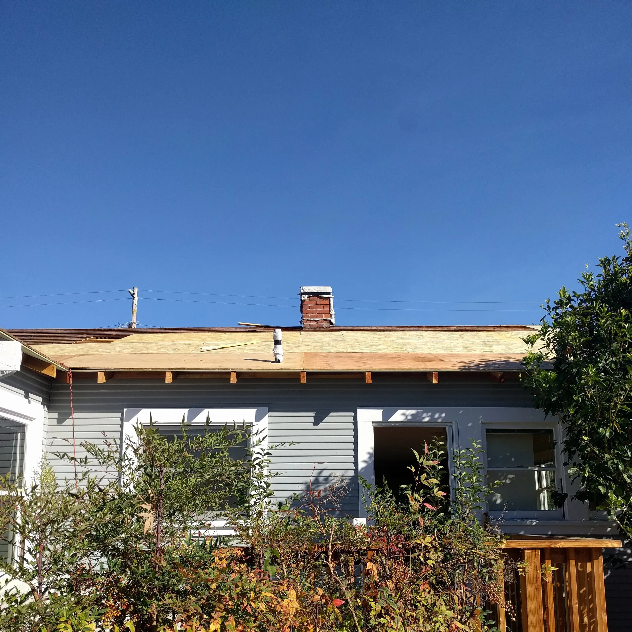 The rear of the house now has new eaves and sheathing instead of "skylights."