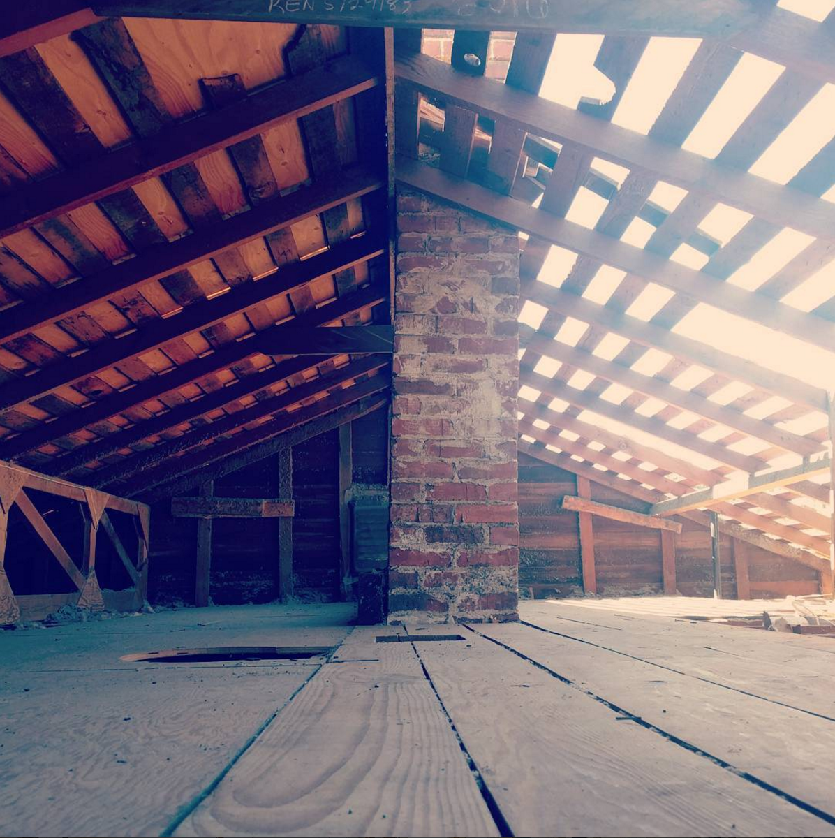 Our attic, with daylight streaming through holes where the roof should be.