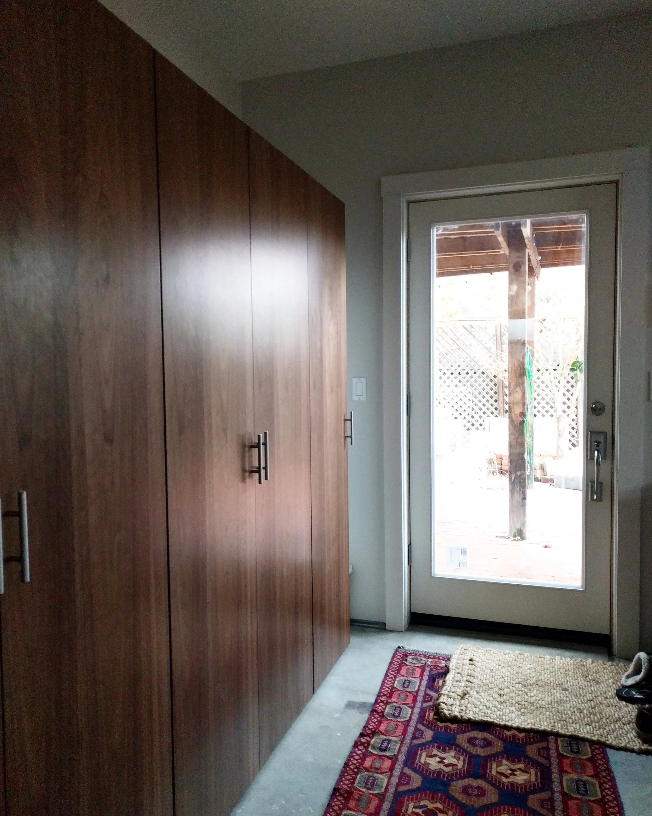 The rear wall cabinets, next to the new glass door.