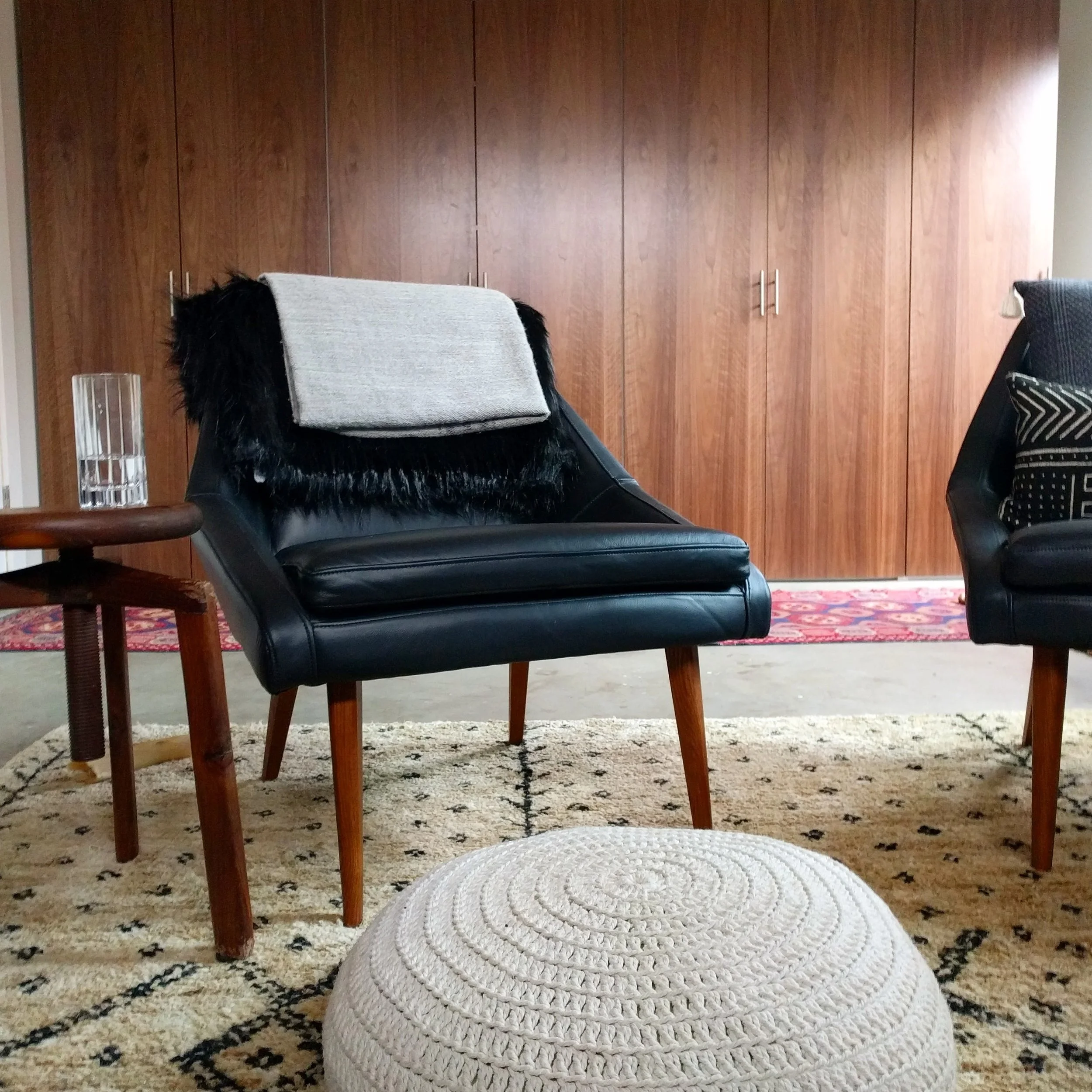 A glimpse of the furniture, with the wall of cabinets behind it.