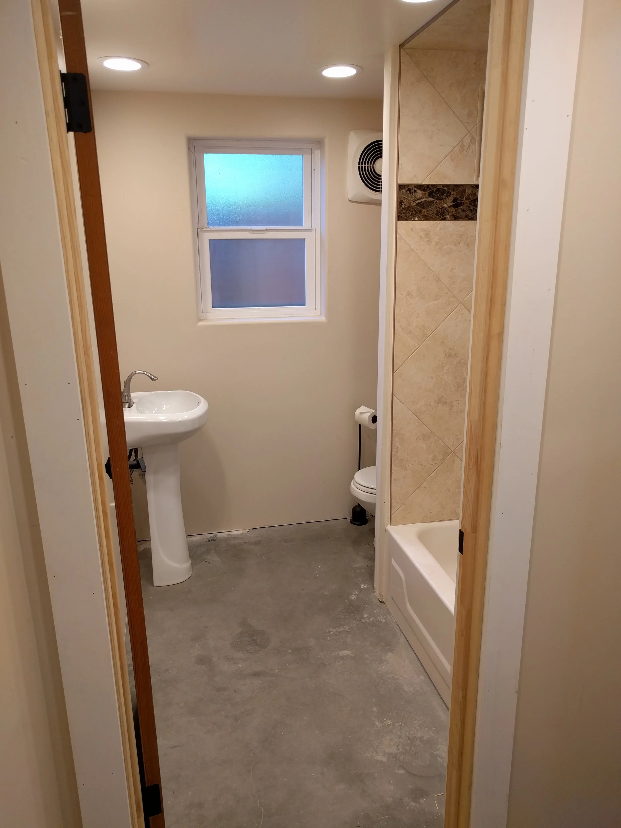 The bathroom as it looked when we purchased the house. Just out of frame are the rhinestones that someone inexplicably installed in the shower.