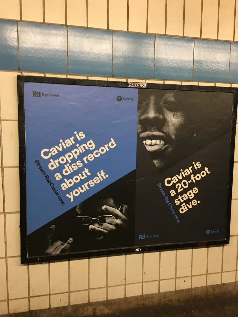 Shots from Spotify Studios in the office. A RapCaviar ad in the subway.