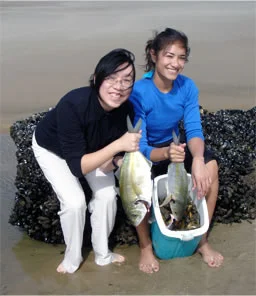 A student and junior doctor learning successful fishing techniques.