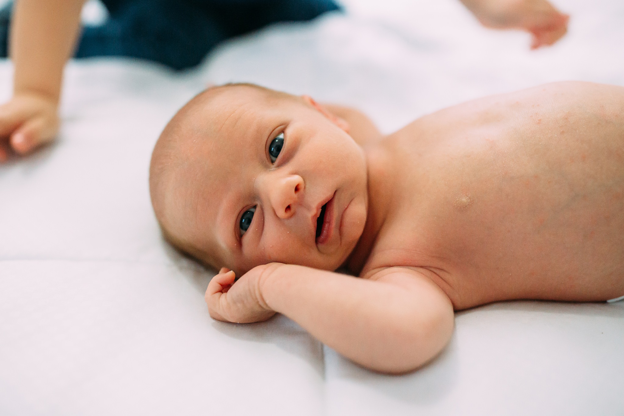 Beautiful Family Snuggles Baby on Bed | Whidbey Island Newborn Lifestyle Photographer