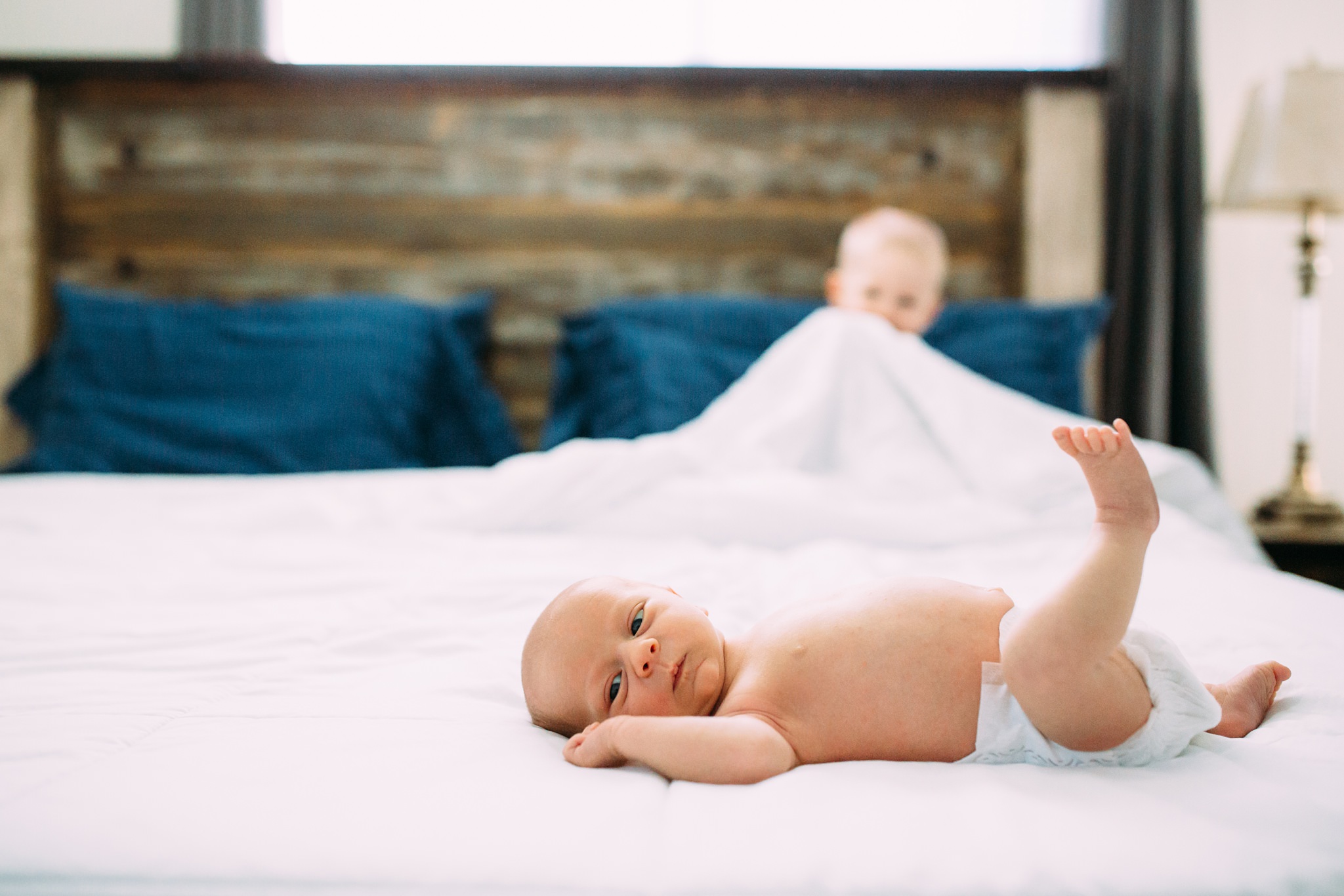 Beautiful Family Snuggles Baby on Bed | Whidbey Island Newborn Lifestyle Photographer