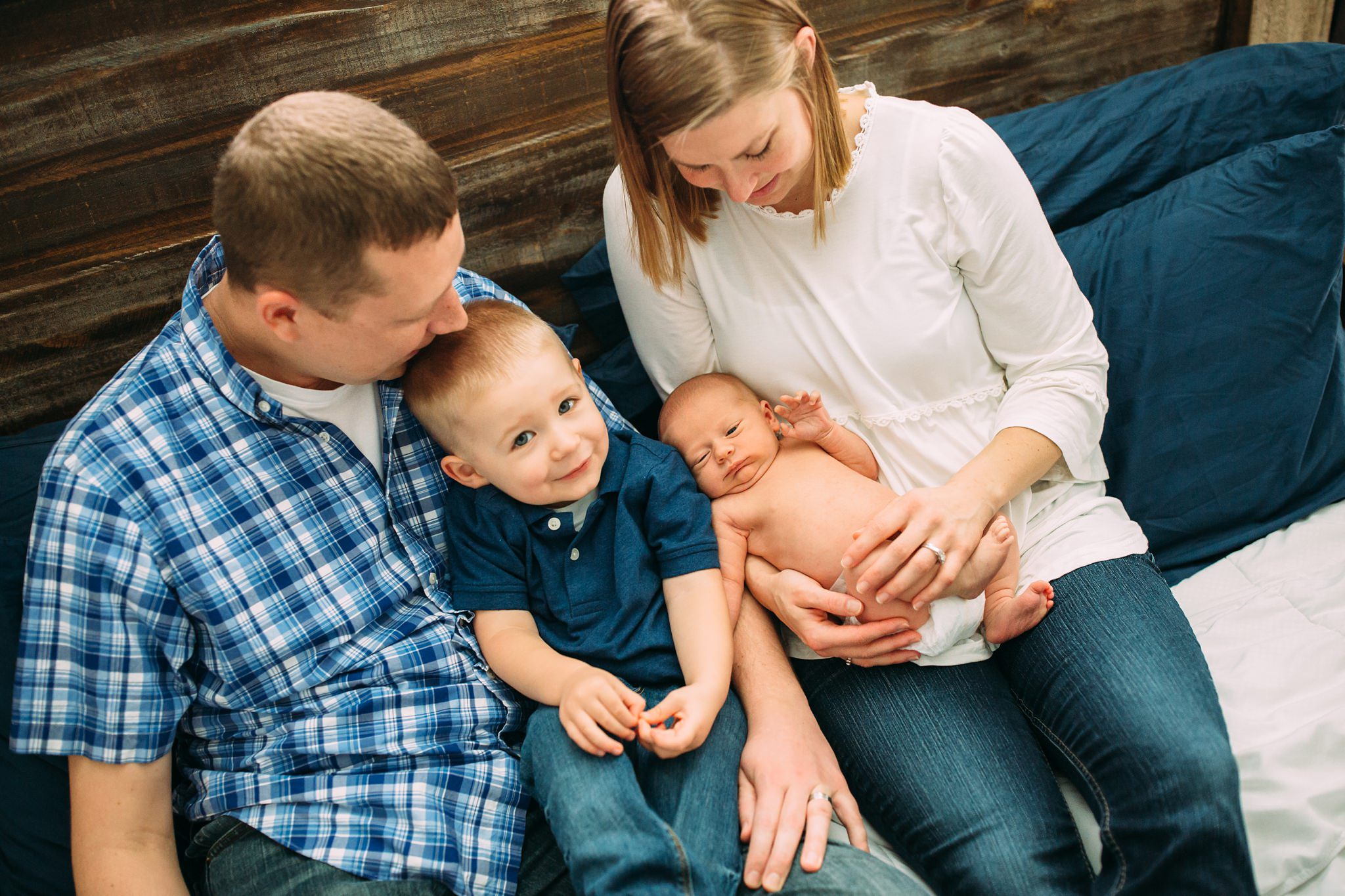 Beautiful Family Snuggles Baby on Bed | Whidbey Island Newborn Lifestyle Photographer