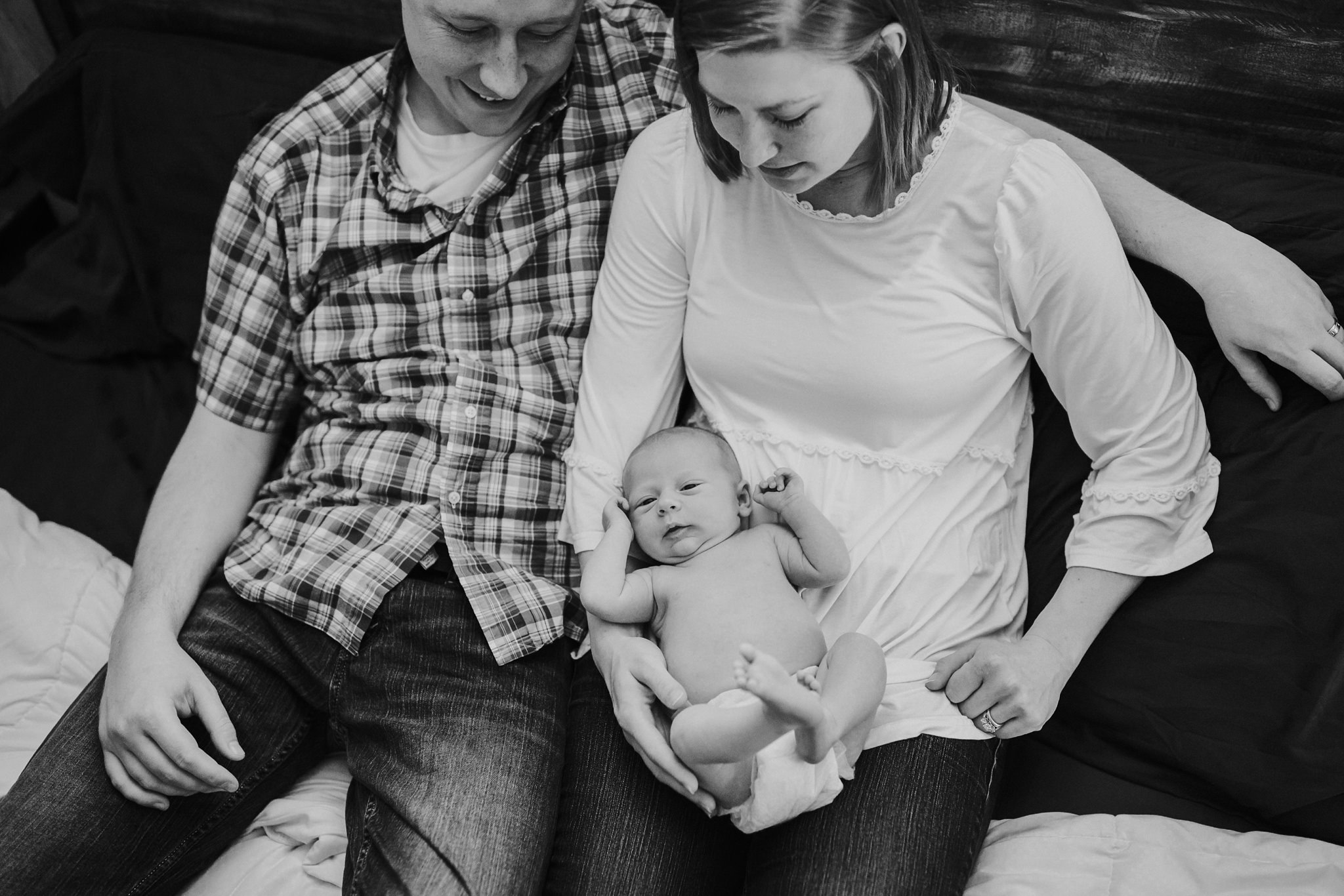 Beautiful Family Snuggles Baby on Bed | Whidbey Island Newborn Lifestyle Photographer