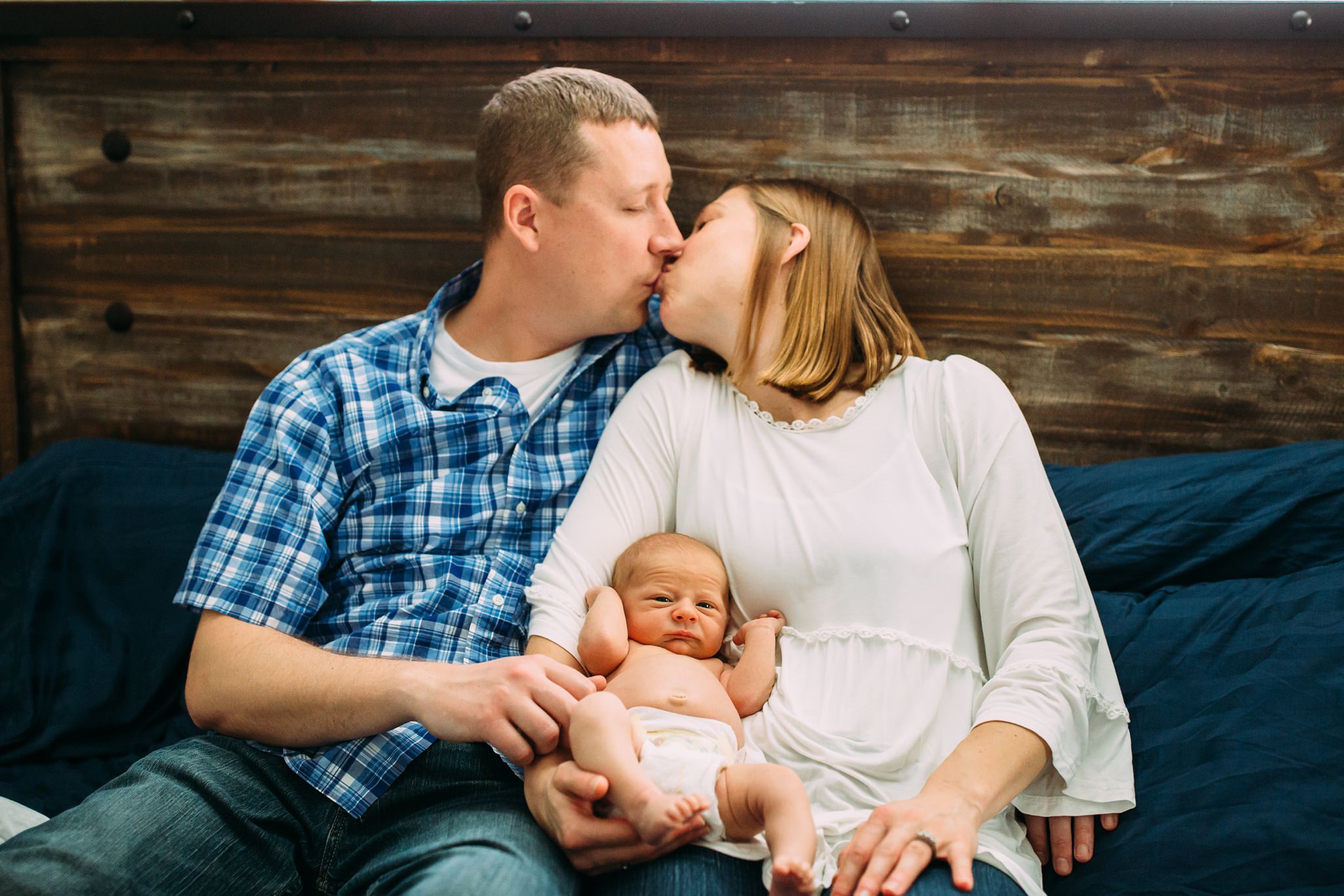Beautiful Family Snuggles Baby on Bed | Whidbey Island Newborn Lifestyle Photographer