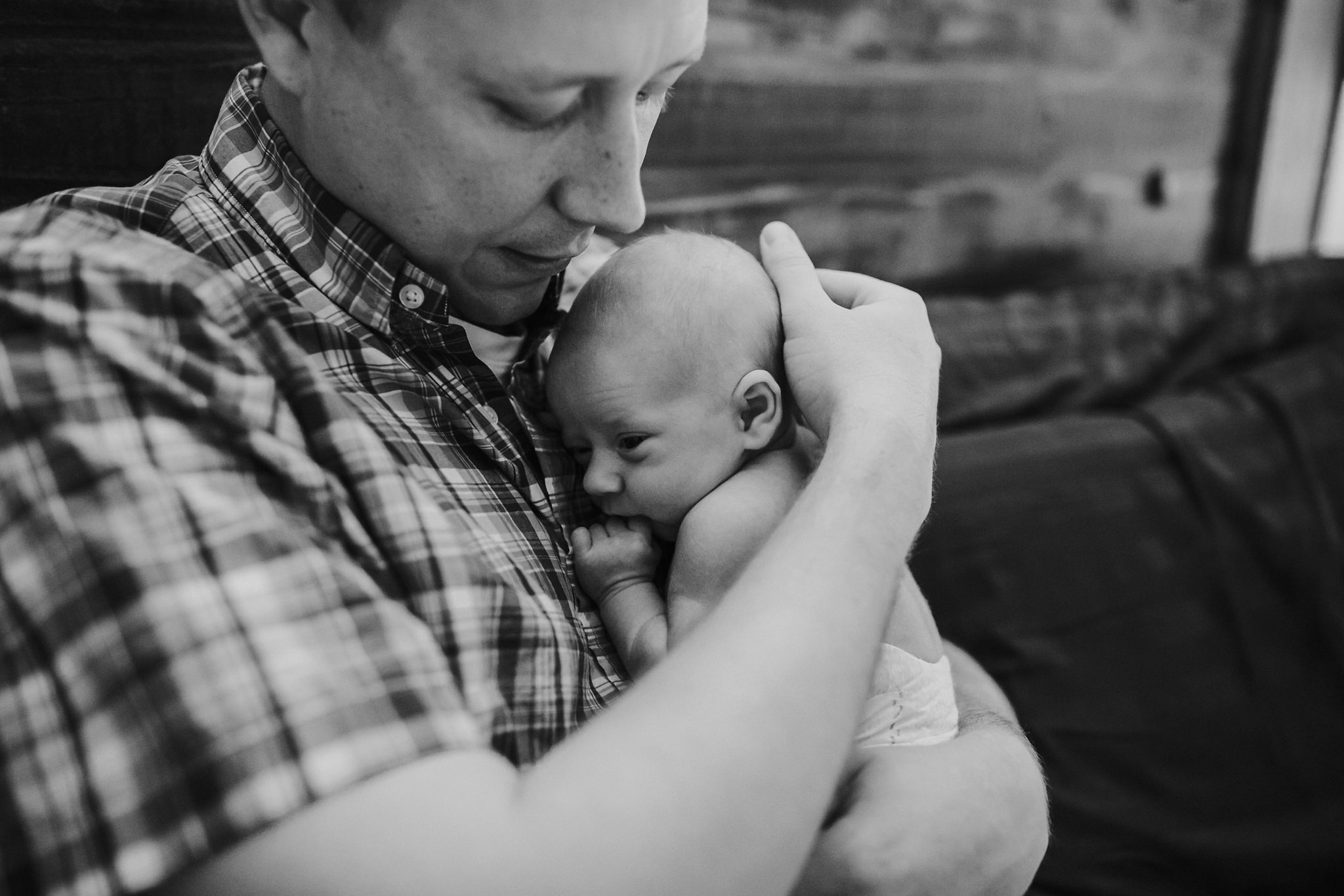 Beautiful Family Snuggles Baby on Bed | Whidbey Island Newborn Lifestyle Photographer