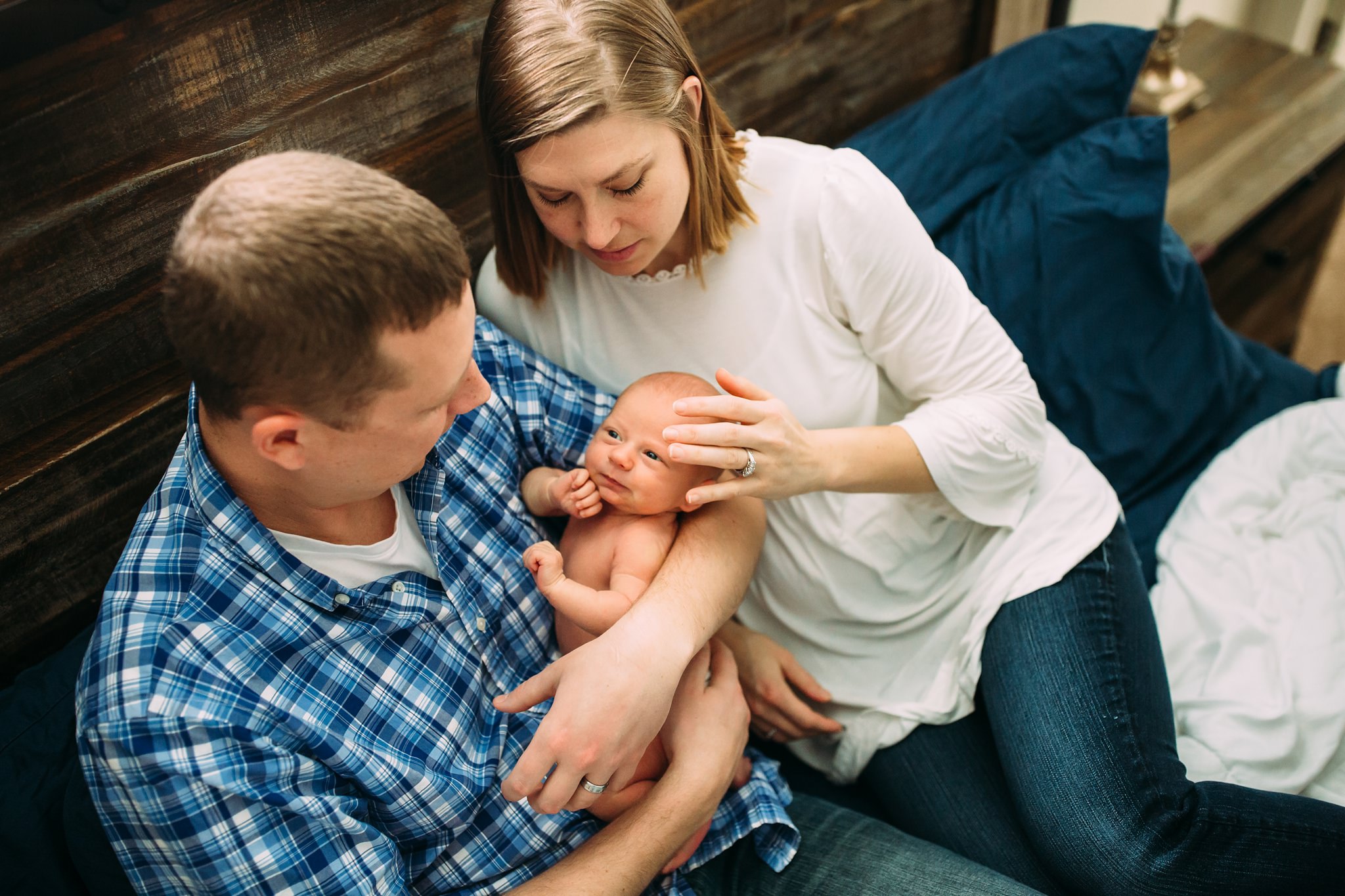 Beautiful Family Snuggles Baby on Bed | Whidbey Island Newborn Lifestyle Photographer
