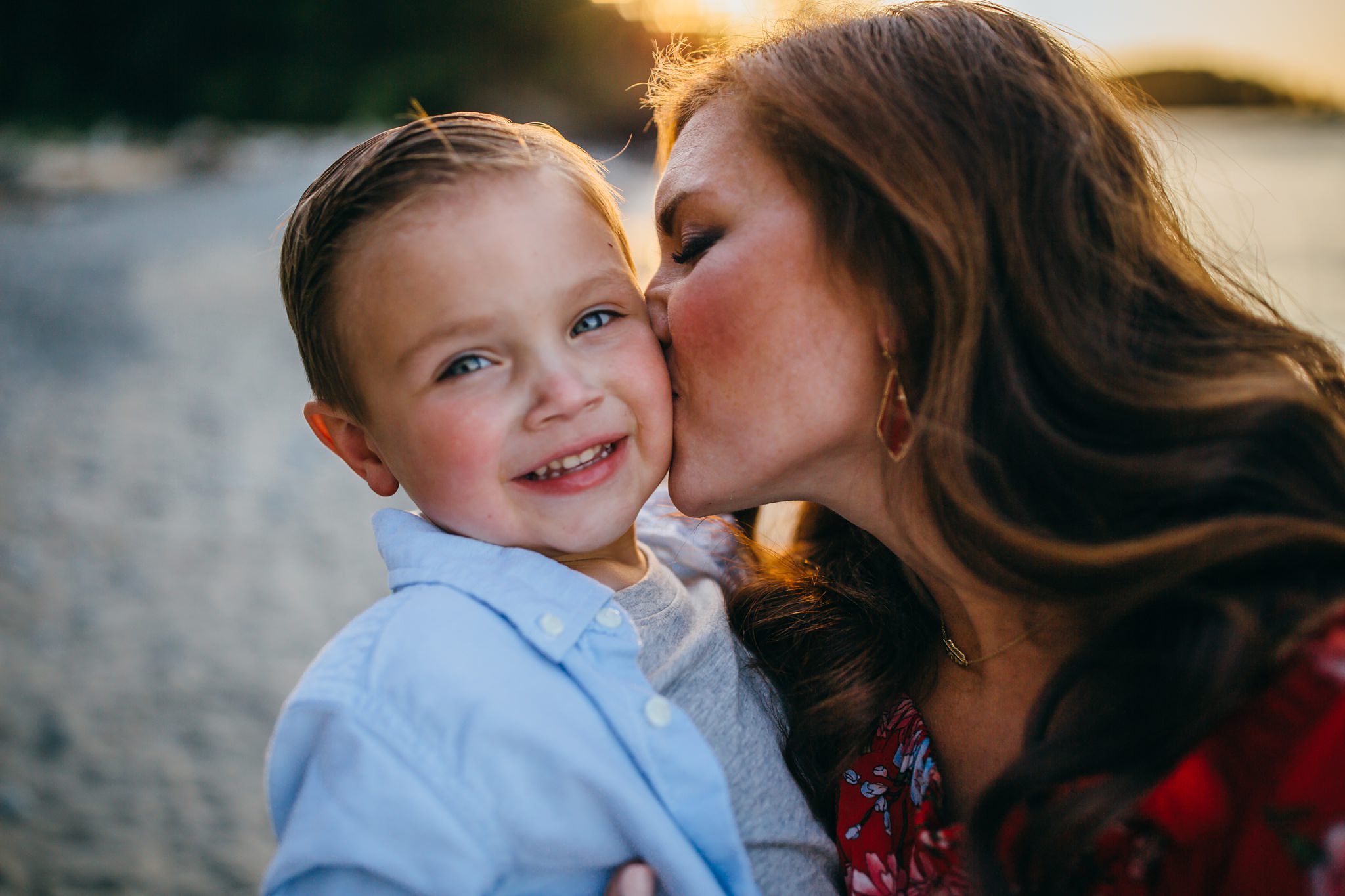 Mom kisses on on cheek on beach | Whidbey Island Family Photographer