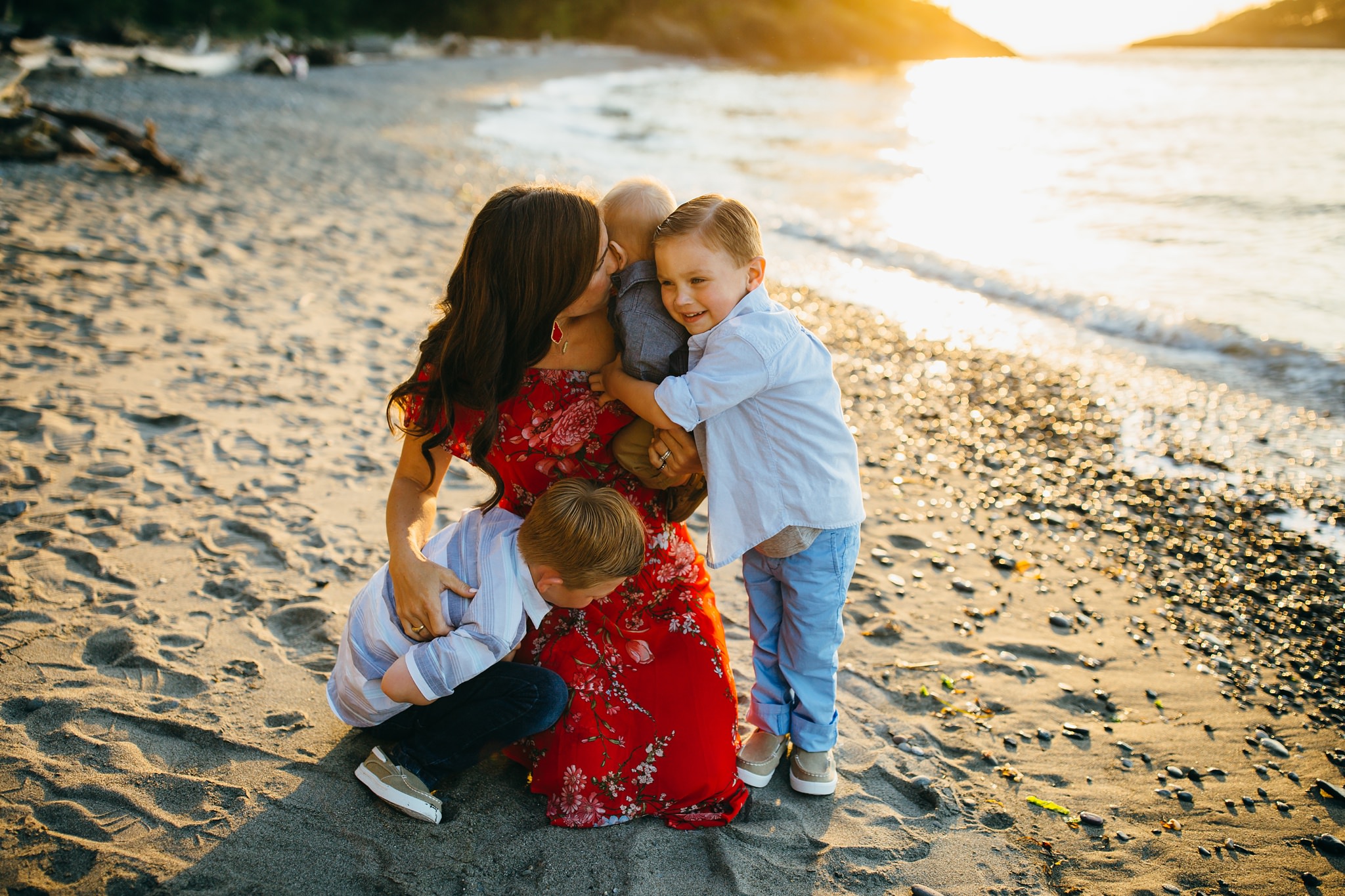 Mother embraces three boys on beach | Whidbey Island Family Photographer