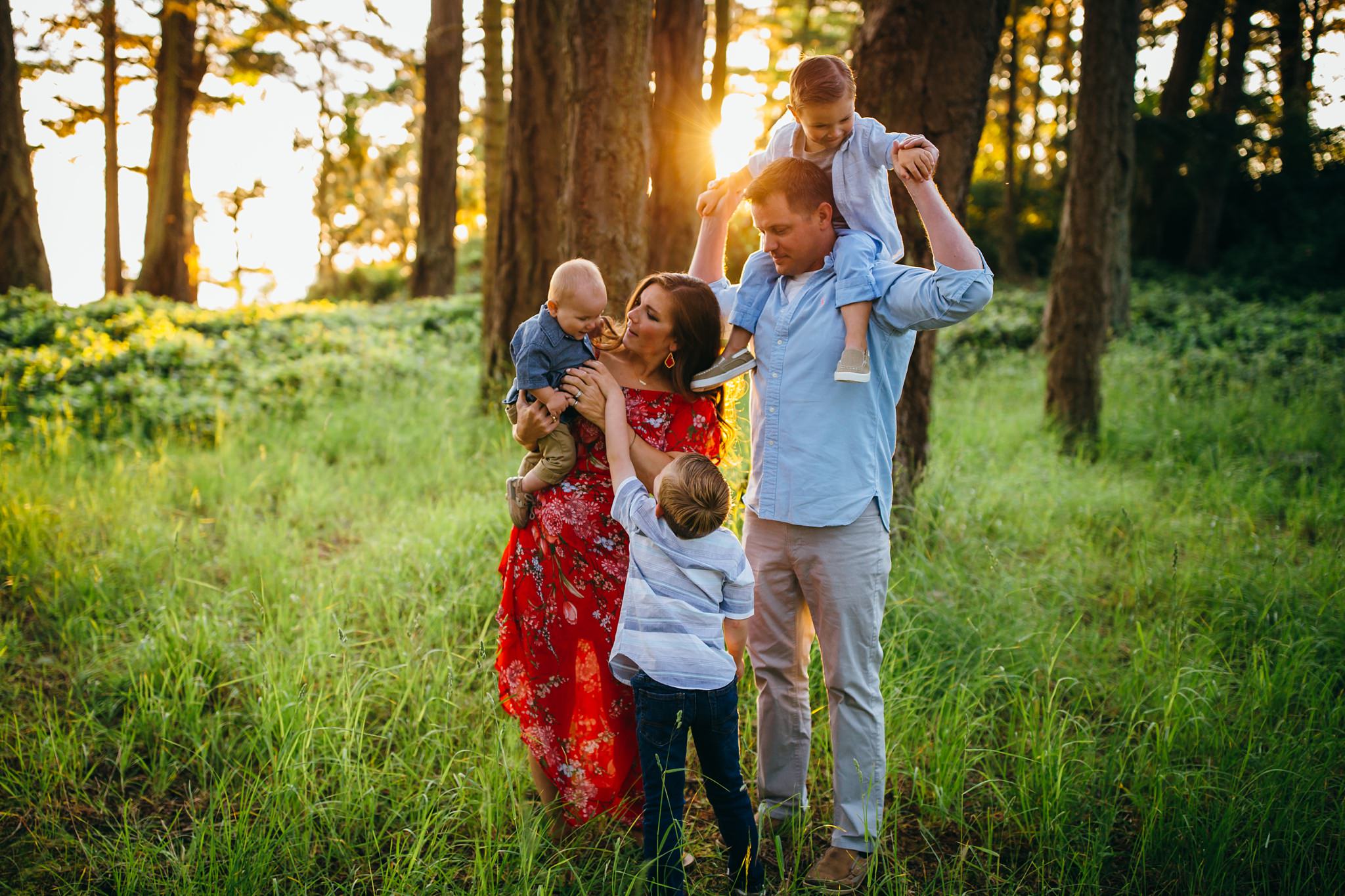 Family hugs in forest at sunset at Deception Pass State Park