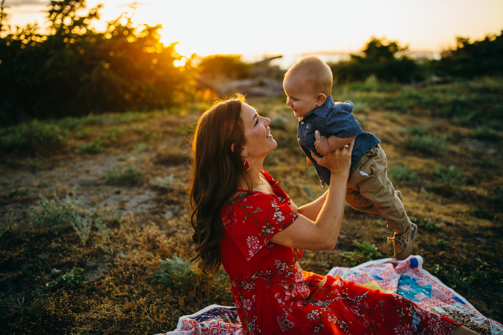 Mother holds baby in air at park | Whidbey Island Family Photographer