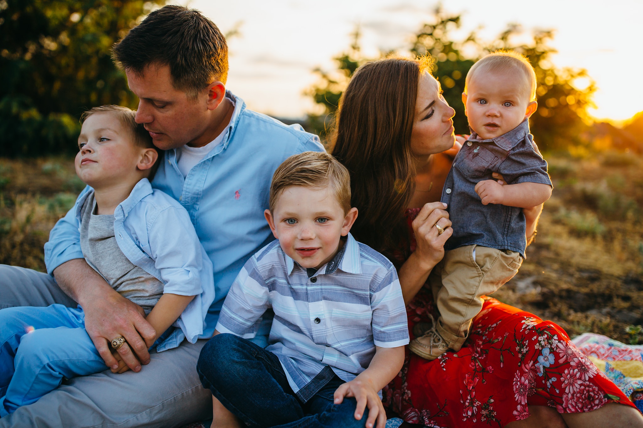 Family sits on blanket at Deception Pass | Oak Harbor Family Photographer