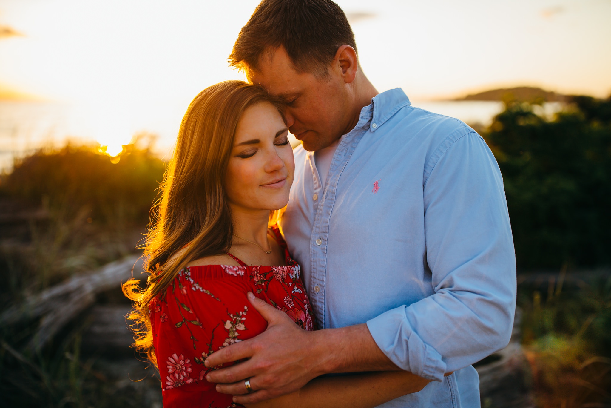 Husband hugs wife on beach | Oak Harbor Family Photographer