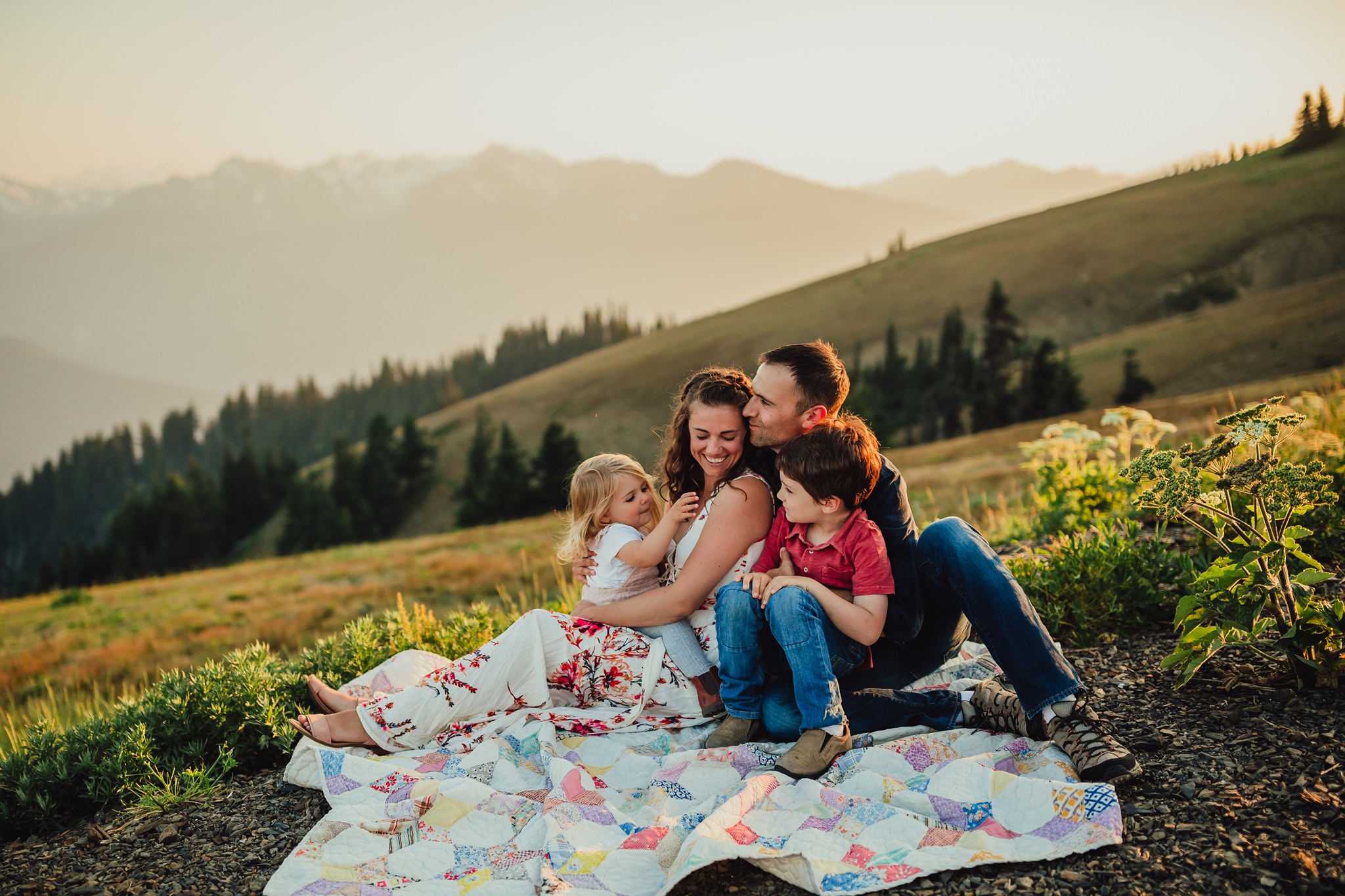 family sits on blankets at hurricane ridge