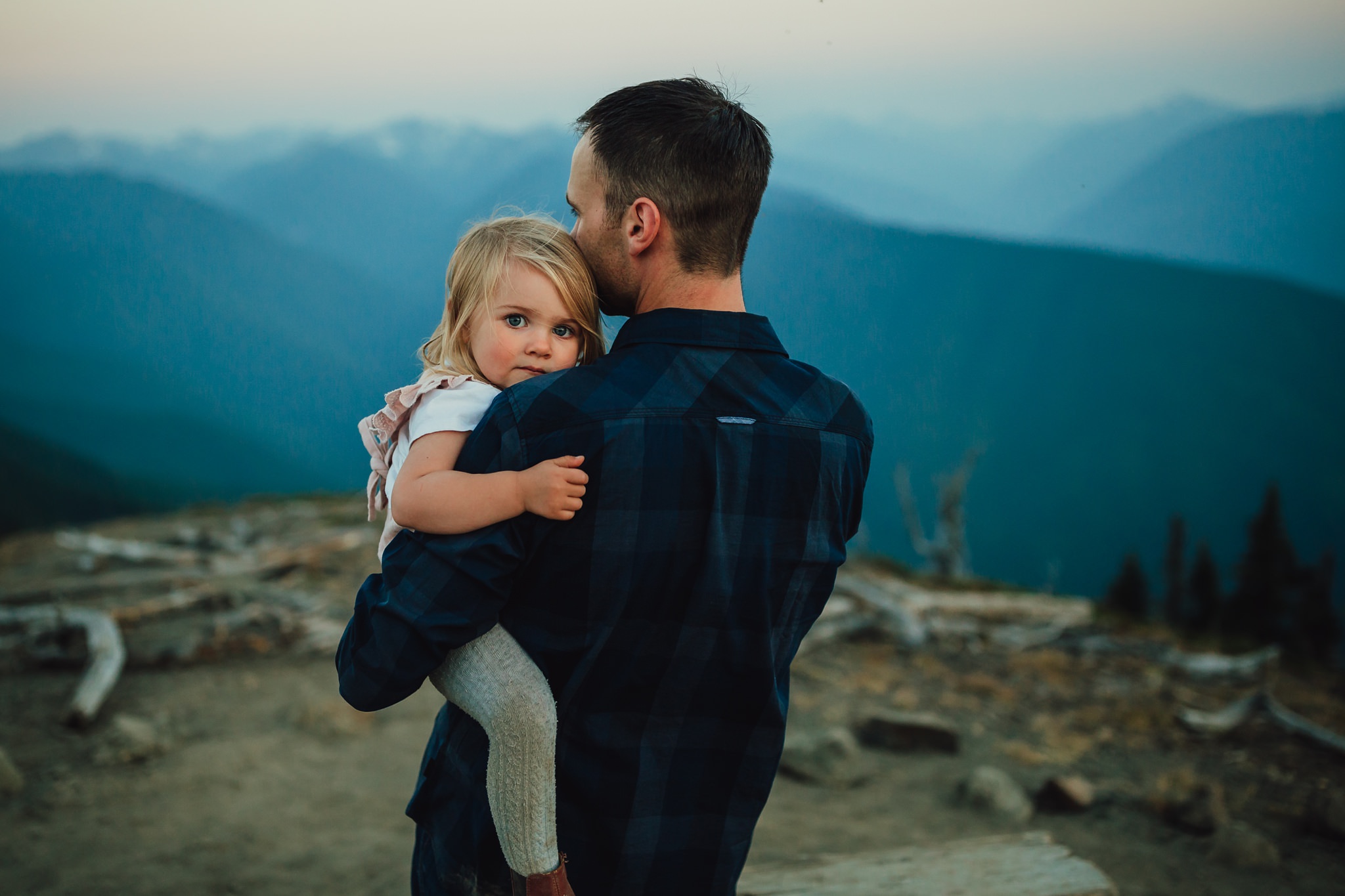 father holds daughter on top of mountain at olympic national forest