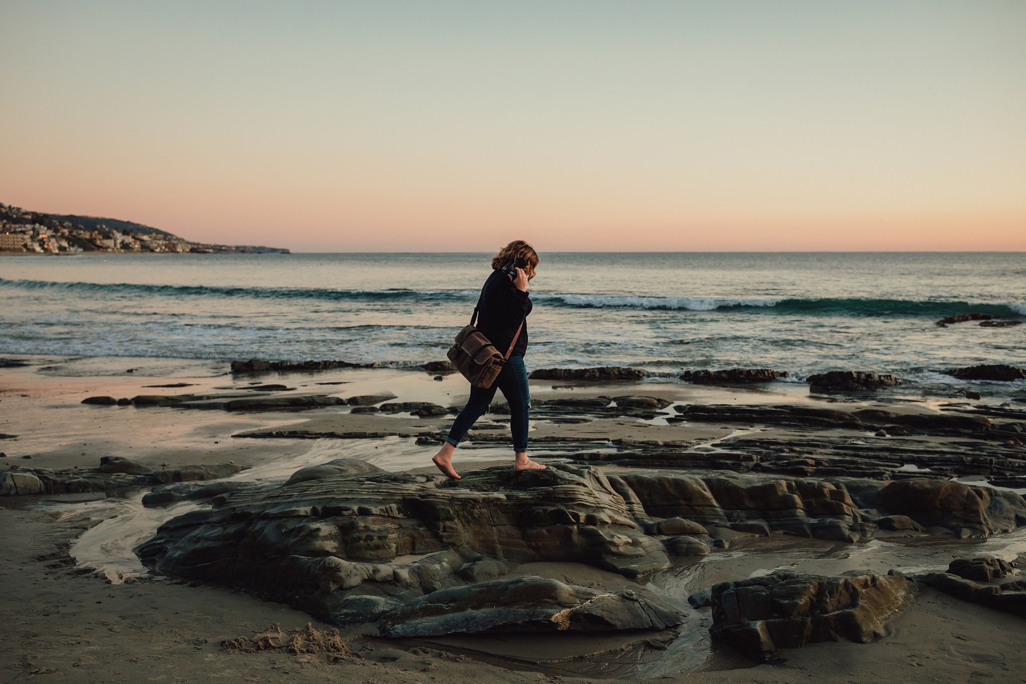 woman walks on rocks at Laguna Beach | Whidbey Island family photographer