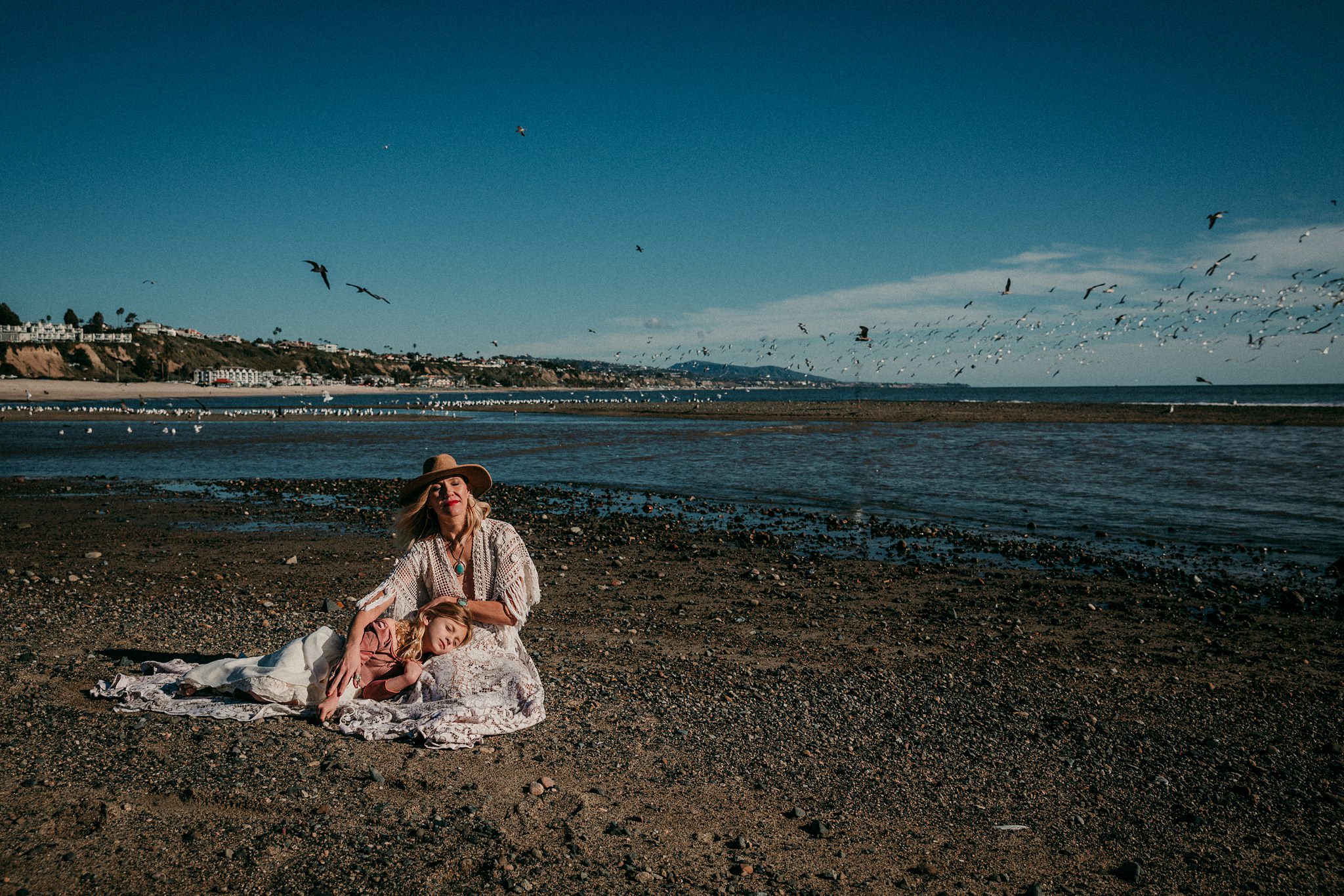 woman and daughter sit on Laguna Beach midday | Whidbey Island family photographer