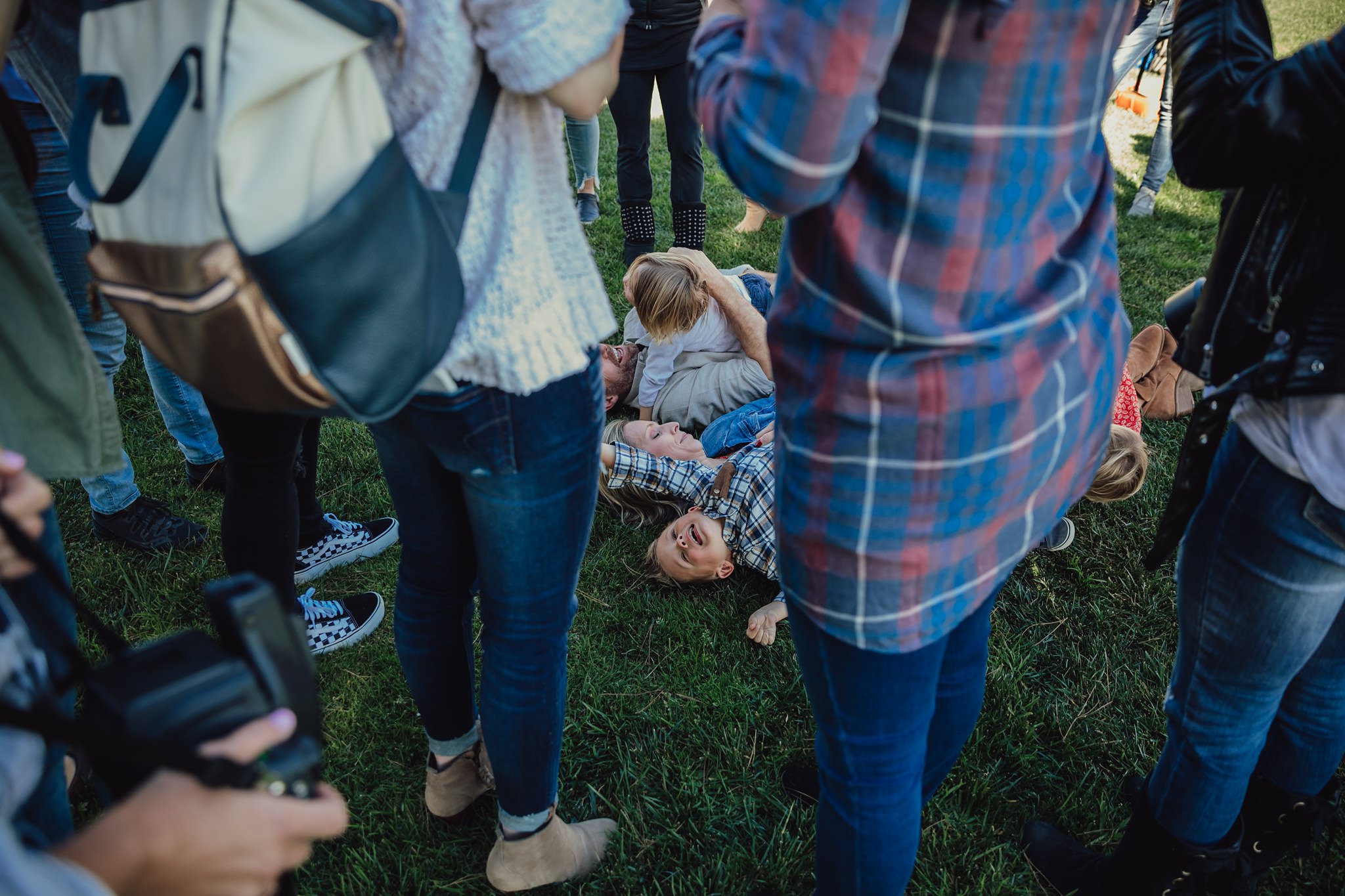 photographers crowd around family playing on grass | Whidbey Island family photographer
