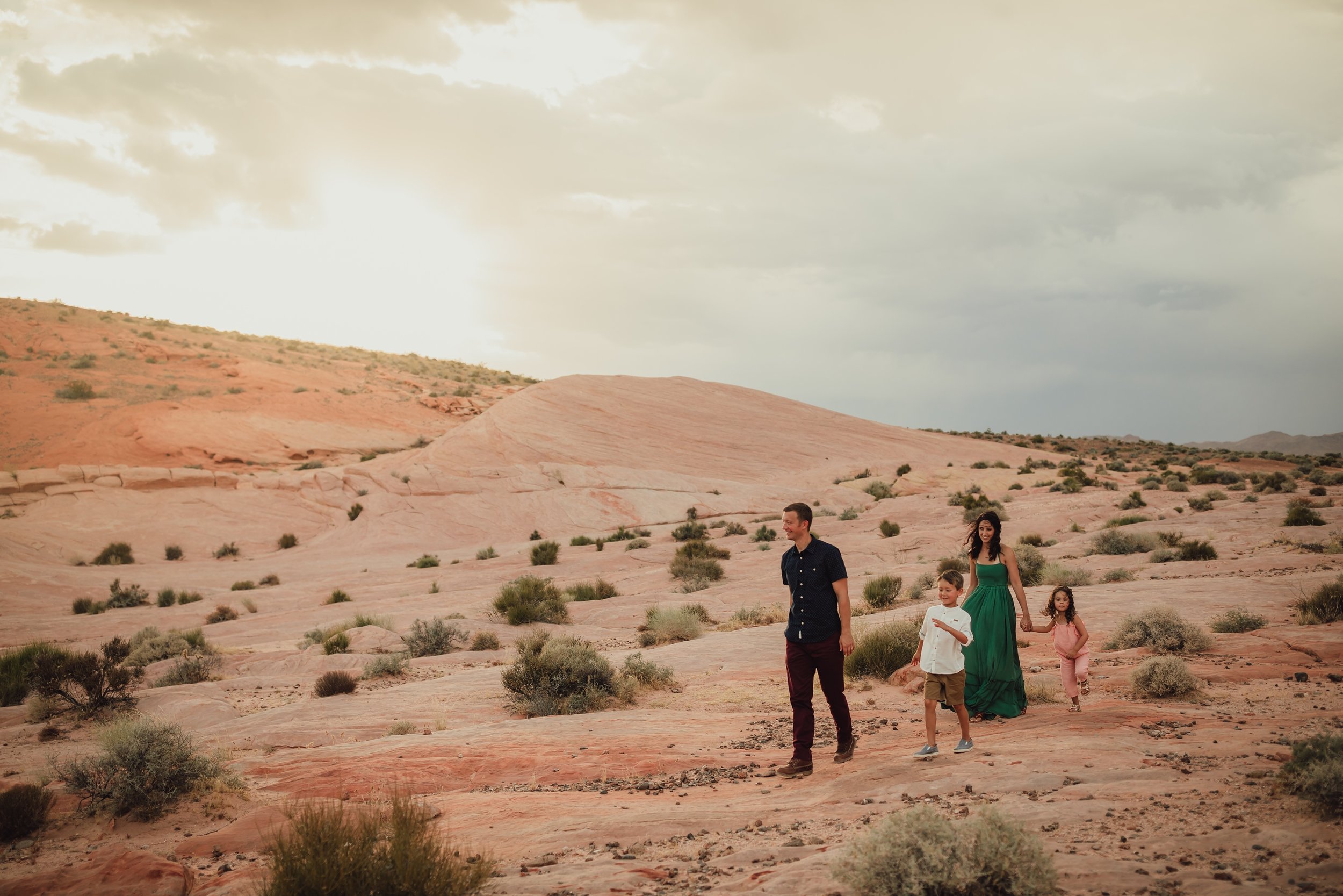 family walks through the valley of fire during photo session