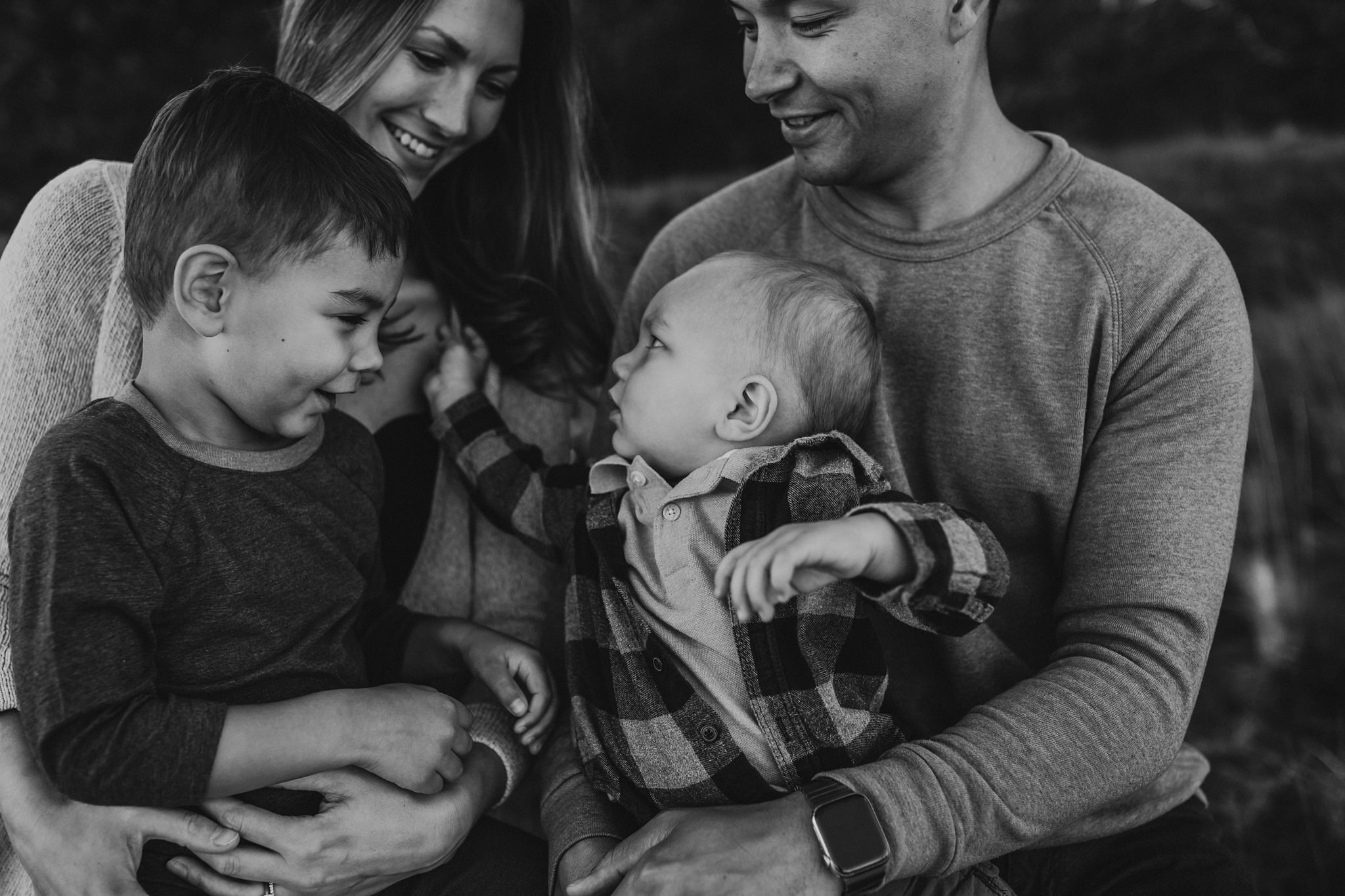 son looks up at mother during family photo session