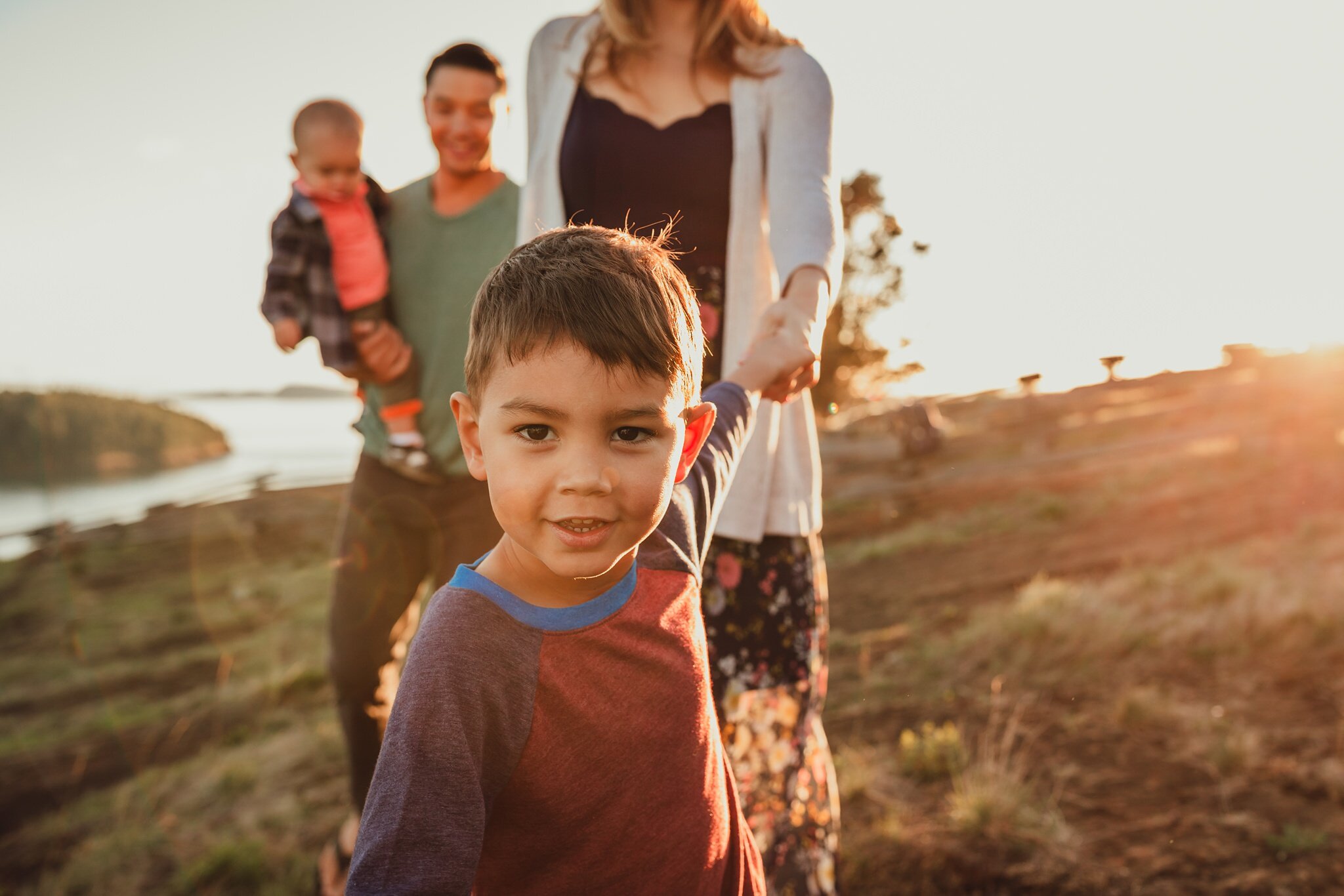 boy leads family on walk during photo shoot