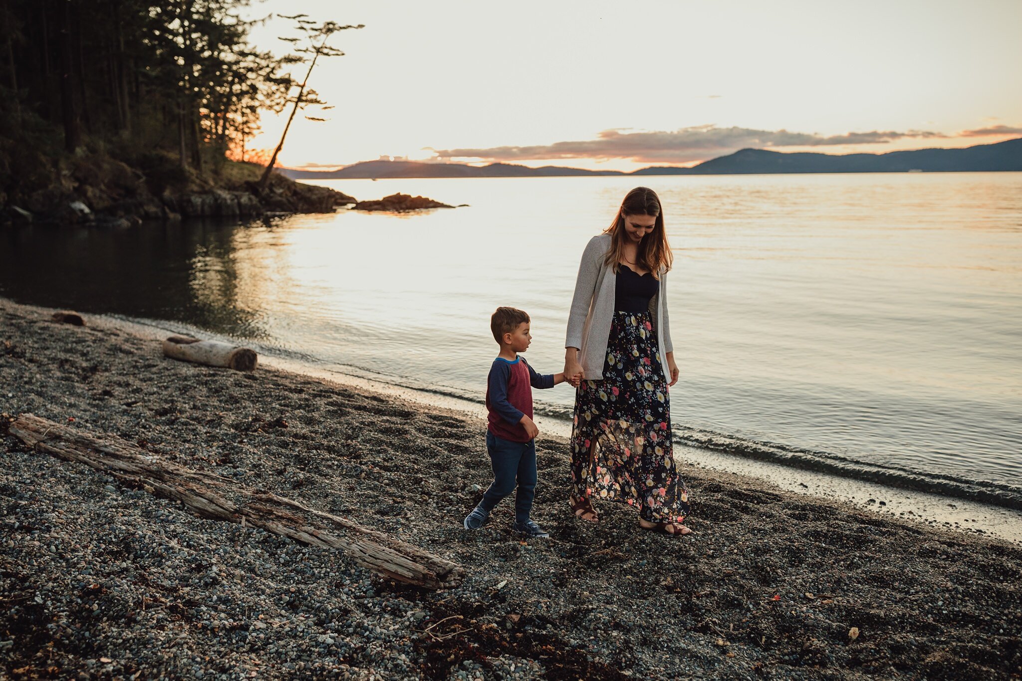 mother and son walk down beach