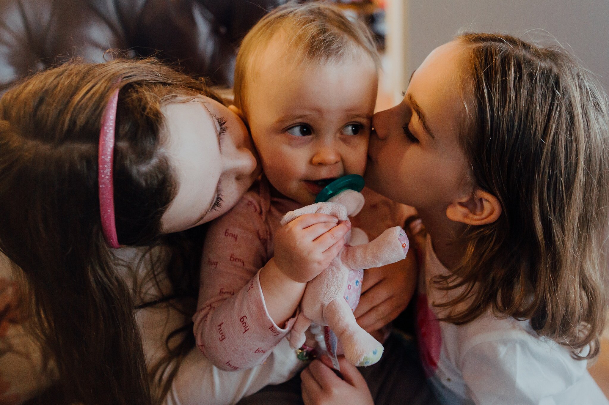 girls kiss baby cousin