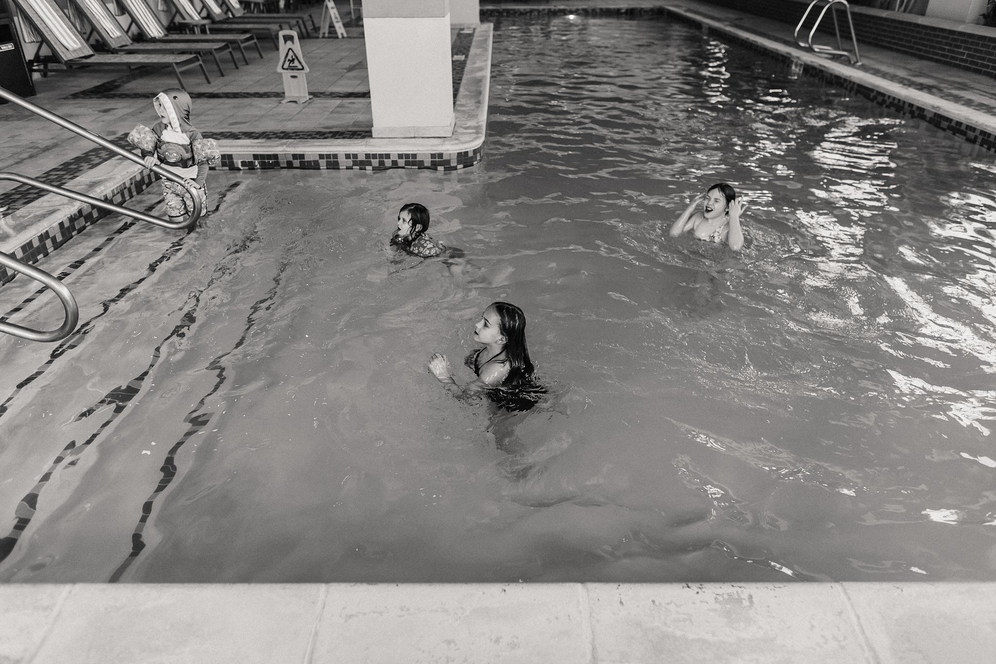 kids swim in hotel pool