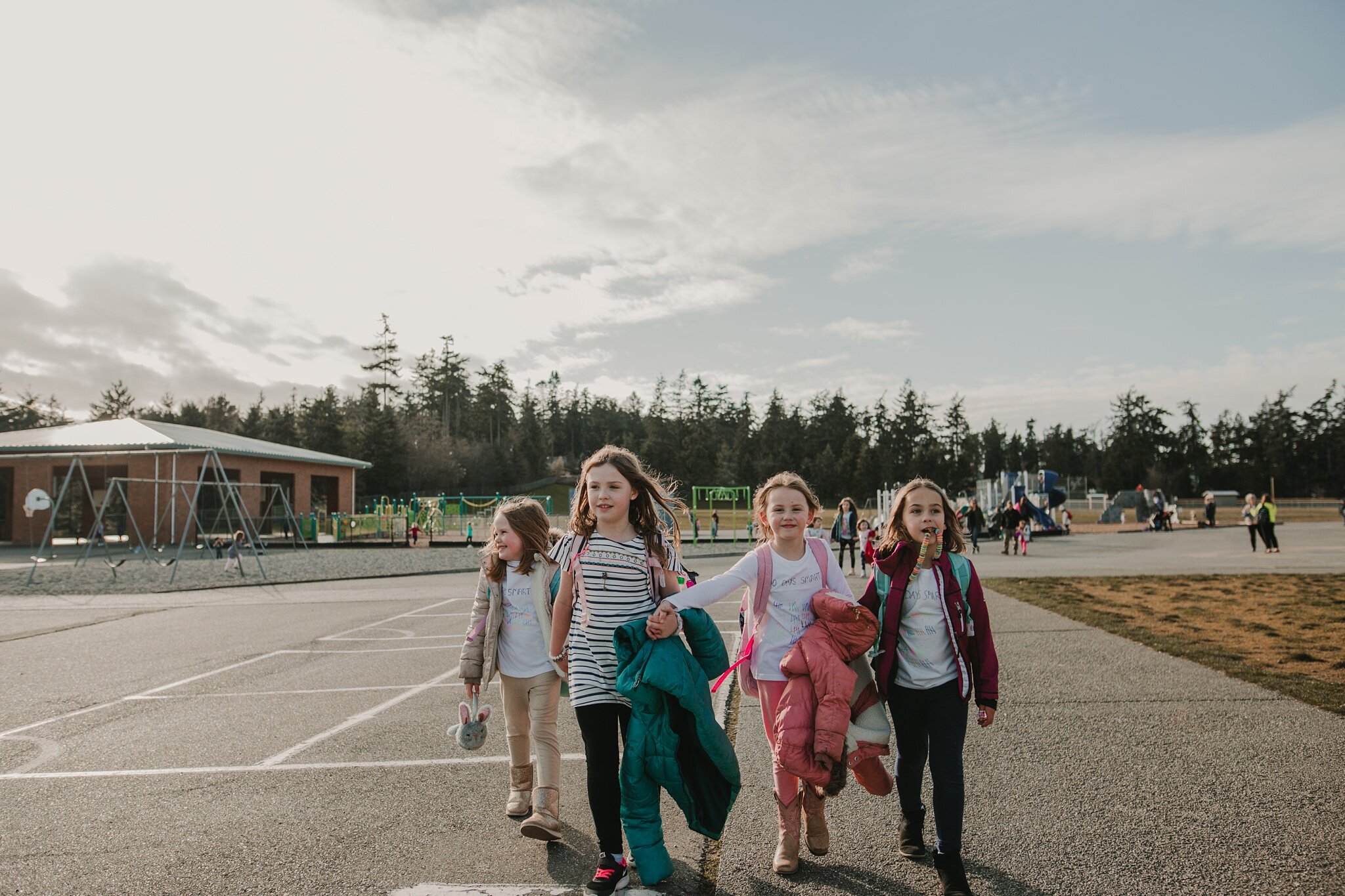 girls walk through playground