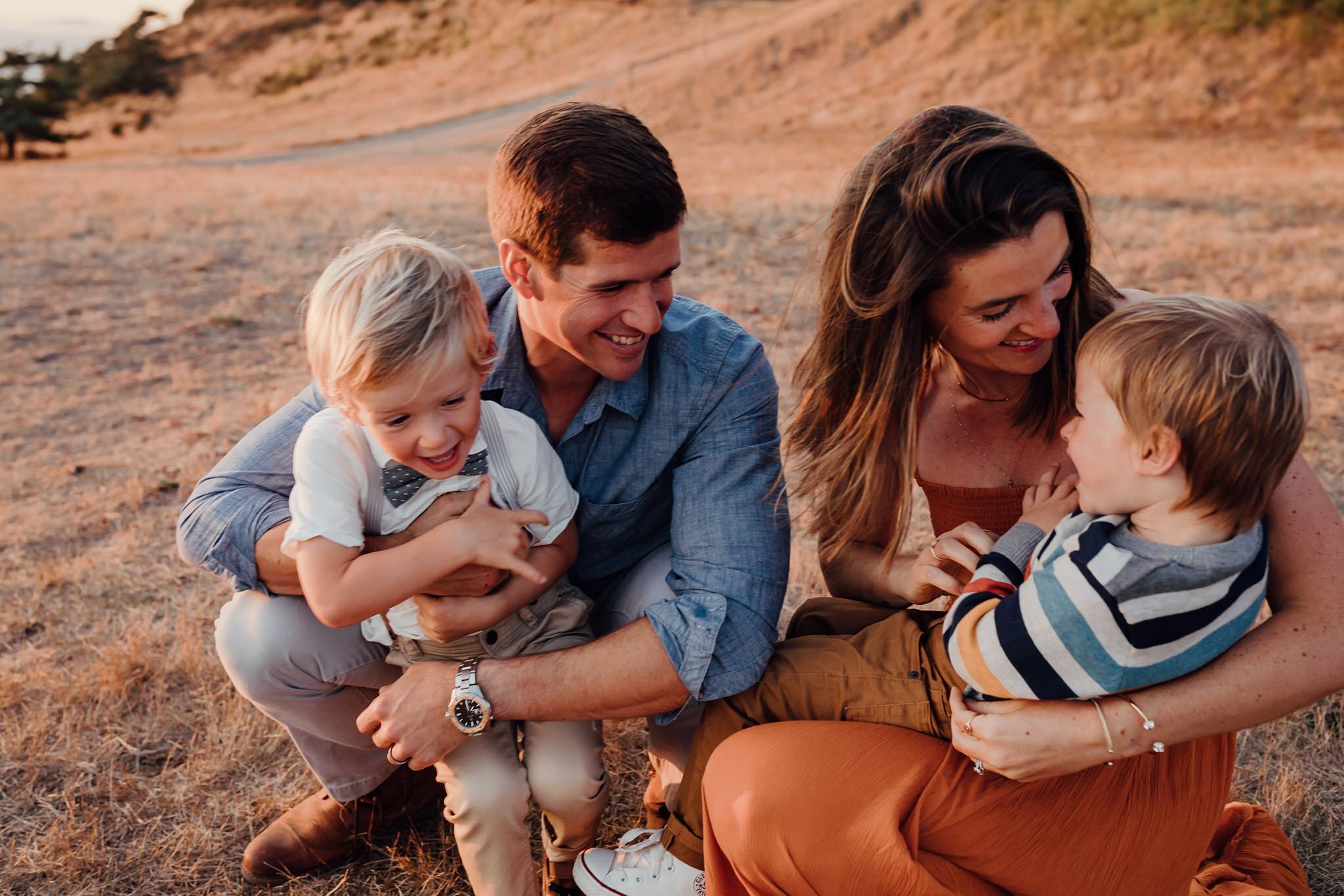 parents snuggle boys during family pictures