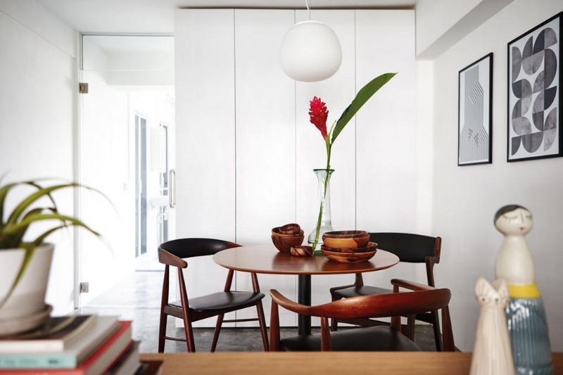 A trio of vintage Danish teak armchairs from us sitting alongside modern pieces. 
