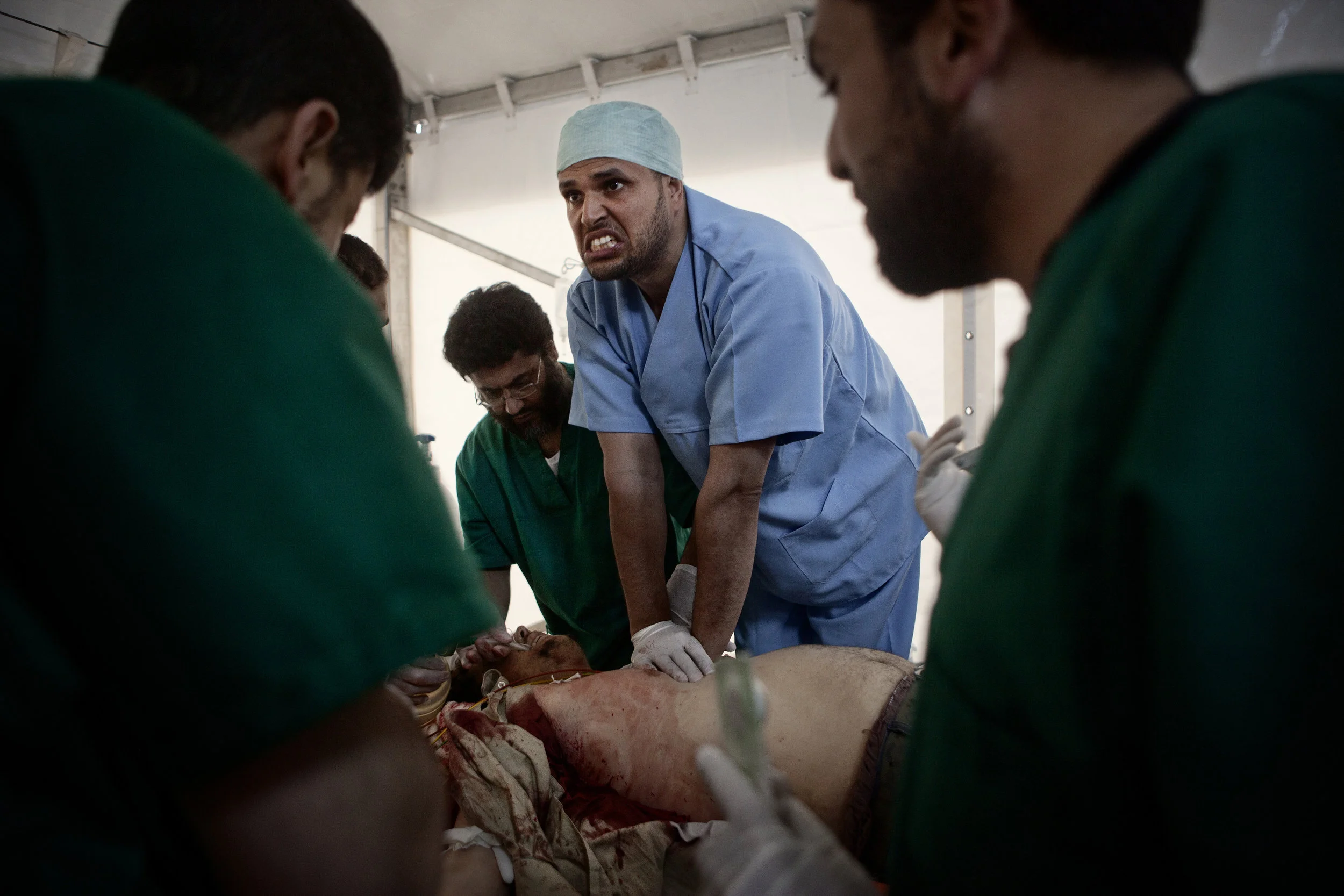  4/15/2011 Misurata, Libya  A doctor desperately tried to do heart compressions on a man who was fatally wounded in heavy fighting in the city, and was bleeding heavily when he was brought to the Hikma hospital, during the seige of the city by Qaddaf