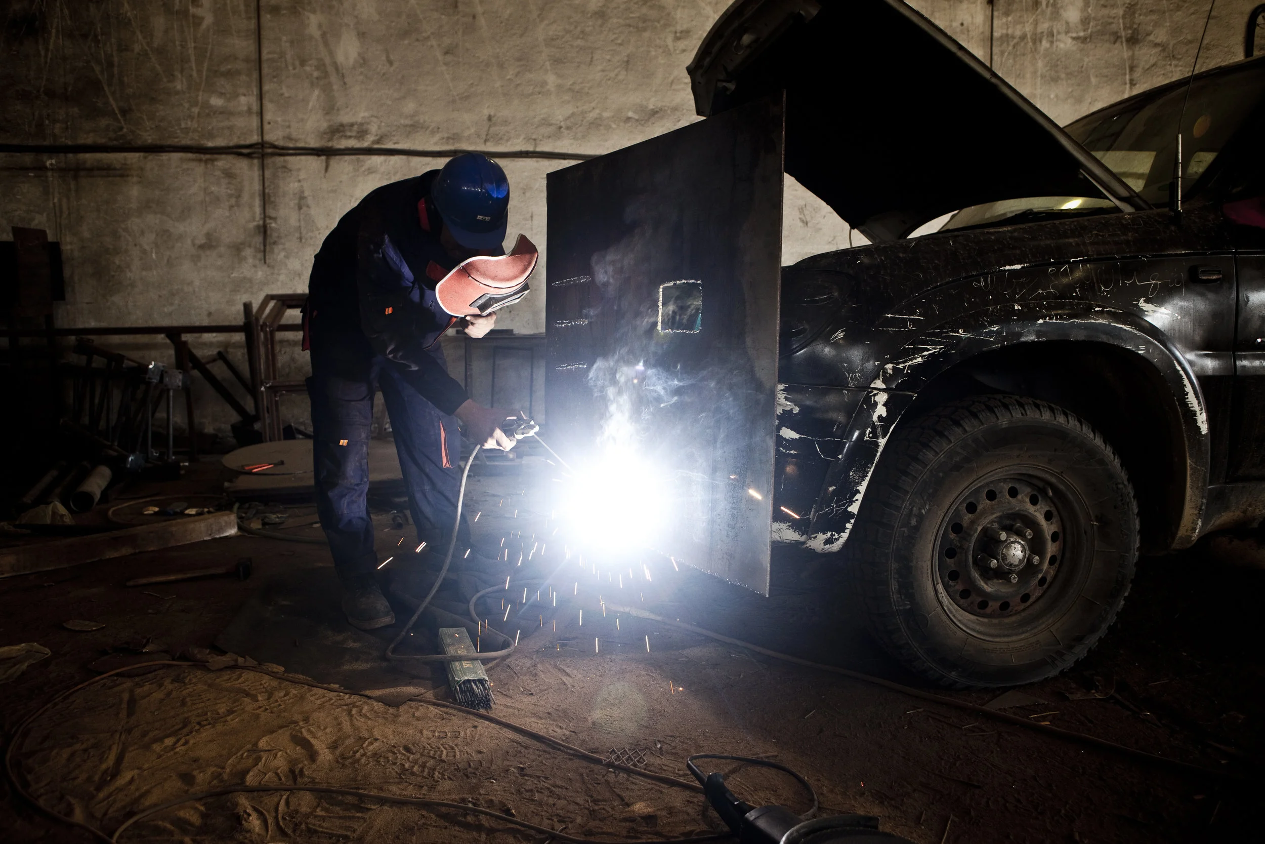  5/2/2011 Misurata, Libya  A Rebel metal worker welded a steel armor plate into place that will be attached to the front of the technical pictured, at a workshop in Misurata. Rebel forces in Misurata had been fighting for almost two months with whate