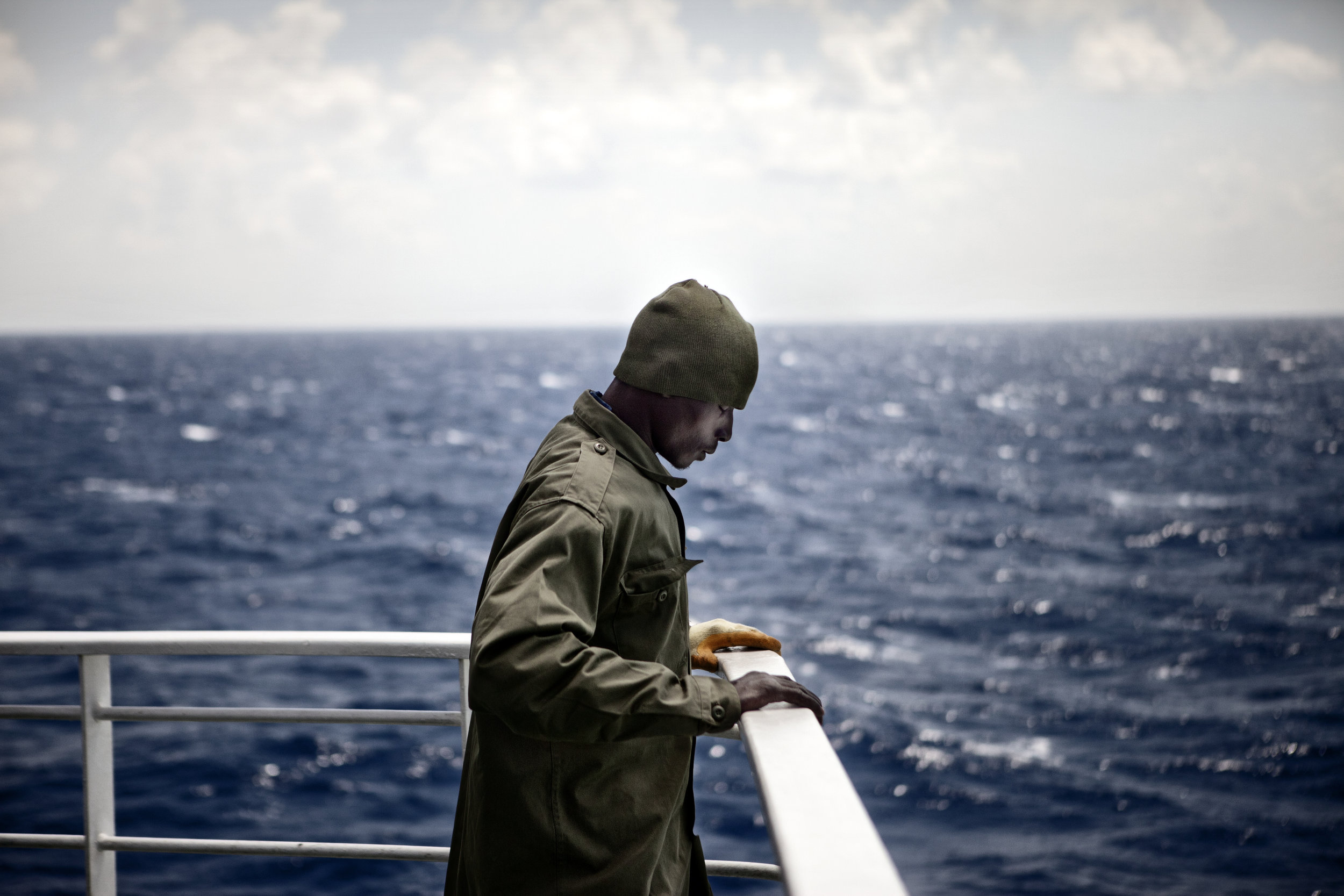  4/18/2011 Aboard the Ionian Star, Off the Coast of Libya  An evacuated migrant worker from NIgeria, his eyes closed, takes a moment to reflect aboard the passenger ferry Ionian Spirit, as it sails from Misurata to Benghazi, Monday. 