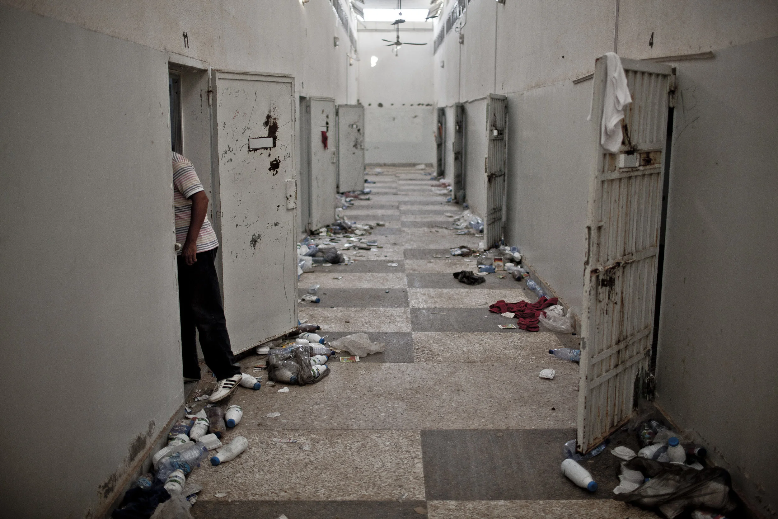  TRAX: 30104960A  8/26/2011 Tripoli, Libya  A Libyan man peered into a cell in the Abu Salim Prison, in the Abu Salim neighborhood of Tripoli, following it's liberation by anti-Gaddafi rebels during the previous days.  In the Abu Salim district, resi