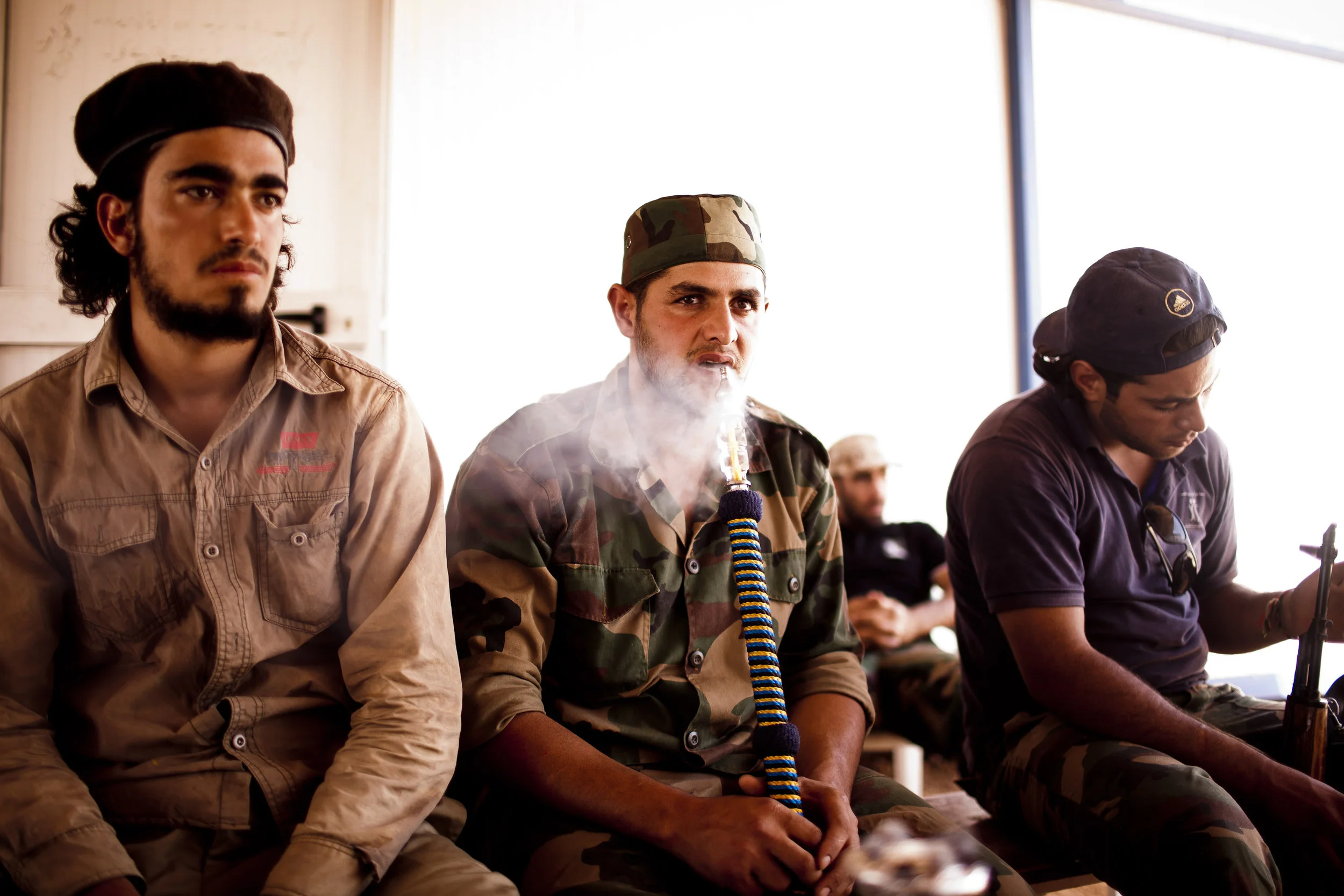  9/1/2011, Outside Sadaada, Libya  Rebels smoked a water pipe in the shade at the last checkpoint on the road between Misurata and Sirte, Thursday. 